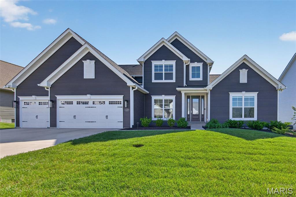 Stunning, 4 bedroom, 3,5 bath, 1.5 story home in the Reserve at Lakeview Farms neighborhood.  This 3,752 sq ft home offers a spacious, open floor design, a main floor Office, main floor Primary Suite, huge second floor Bonus Room and a gourmet Kitchen! 
The exterior is impressive with vinyl siding, an 8 foot tall Entry door, an oversized 3 car garage, architectural shingles, carriage style garage doors, landscaping and lawn irrigation, professional landscape and more.  Luxury features include 9 foot ceilings on the main floor, a two story Entry foyer, an Office with glass French doors, formal Dining Room, Great Room window wall. linear electric fireplace, on-trend gourmet kitchen, 42 inch cabinets, roll out shelving, soft close feature, quartz countertops, tile backsplash, island with seating bar, gas cooktop, chimney range hood, walk in pantry, stainless steel appliances, wall oven, microwave, dishwasher, refrigerator, luxury vinyl plank flooring, wrought iron stair spindles, main floor Primary Suite, walk in closet with organizers, luxury Primary Bath with soaking tub and separate shower, bench seat in the shower, raised height split vanities, separate water closet, main floor laundry room and more.  The second floor is amazing with a huge Bonus Room, 3 spacious bedrooms, two bathrooms (one is a shared bath) and all bedrooms have walk in closets, In addition, there is a dual HVAC system, 2 humidifiers, 50 gallon water heater, 2 electric panels, insulated garage doors and added width stairways.  There is a large patio, backyard bordered landscape and a pergola for outdoor enjoyment. Enjoy neighborhood amenities including a lake with a fountain, walking trails, playground and picnic area. Students will attend desirable Francis Howell schools. The incredible Veterans Tribute Park, Whitmoor Country Club, the Katy Trail and Highway 364 are minutes away.  Spectacular home, amazing location, so much to love!