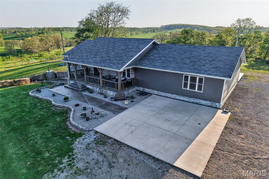 If you've been dreaming of space, privacy, and a property that's already set up for the lifestyle you want then this is it! 58.58 acres, 5 ponds, and a 30x40 shop, this property is set up and ready for country living!  The beautiful remodeled home offers over 5,000 sqft of living space, 2 full kitchens, 2 laundry areas, and a flexible layout ideal for extended family living or guest space.  The main level features 4 bedrooms, 2 and half baths, while the full walkout basement includes 3 non-conforming bedrooms/bonus rooms, a full bath, second kitchen, additional living space and the second laundry room.  Additional features include a 10x30 storm cellar under the porch in the basement. Recent interior improvements include custom solid hickory cabinets on main level with granite countertops, new HVAC system, outdoor wood stove, new water heater and a commercial grade water softener with filtration system. In addition the well has been upgraded with a larger motor. Exterior updates enhance both curb appeal and efficiency  including new siding and rock, new double-pane double hung windows with screens on front of home, new soffit with lighting, updated beams, posts, and railing. Enjoy outdoor living with a stamped concrete front porch and back patio. The property is well equipped for rural living with a 30 x 40 metal shop with concrete floors, electric, and overhead hoist. The property also features a carport, garden area, newly built chicken coop, some new fencing, and a corral for livestock making it ideal for a hobby farm or agricultural use. An Abundance of deer and turkey give great opportunity for hunting right on your own land! Located just 6 miles from Grovespring, Missouri, 18 miles from Hartville, and 22 miles to Lebanon, you're right in the pocket of Ozarks rural living with access to multiple small towns! With stunning views and a perfect blend of privacy and functionality, featuring open fields and 5 ponds that provide water for wildlife or could easily be stocked for fishing. This property has so much to offer!  Space, versatility and extensive updates all in a peaceful setting. The hard work has already been DONE, just move in and enjoy!