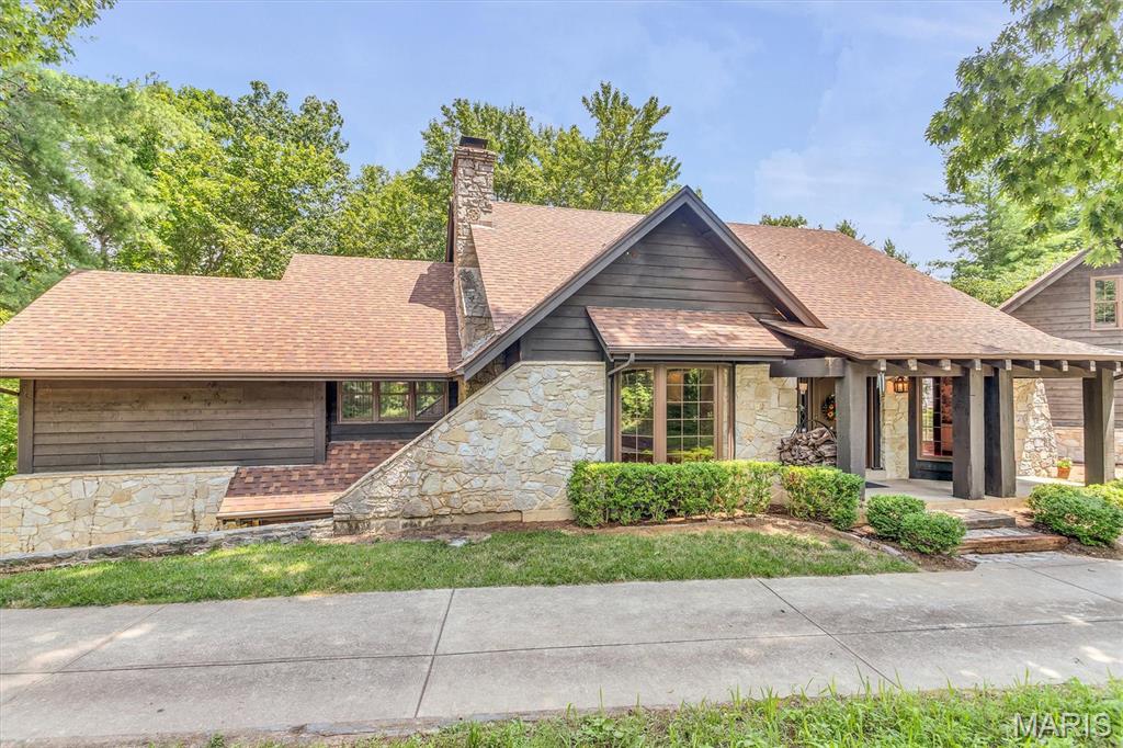 Incredible opportunity to own this 4 bedroom and 3 full bath ranch home on 3.63 acres in the heart of Chesterfield with an oversized 3 CAR garage!!  This home is perfectly situated off of Wild Horse Creek road and features a secluded view and breathtaking woods.  The oversized 3 car garage features a loft area with many possibilities. The two tiered deck backs to quiet woods and offers complete privacy.  The soaring and stunning stone fireplace in the great room is a show stopper! New roof in 2025. The spacious primary suite has a fireplace and full bath.  The main floor laundry is right off the garage and has a large pantry. The 42" kitchen cabinets are beautiful complete with a walk-in pantry.  The walkout finished lower level features 2 bedrooms and a full bath with an additional family room complete with a wood burning fireplace. The unfinished portion of the basement is perfect for a workshop and there is ample storage. Bring your decorating touches to transform this lovely home into your paradise. This is a rare opportunity to own a private retreat in Chesterfield and the location is convenient and incredible!