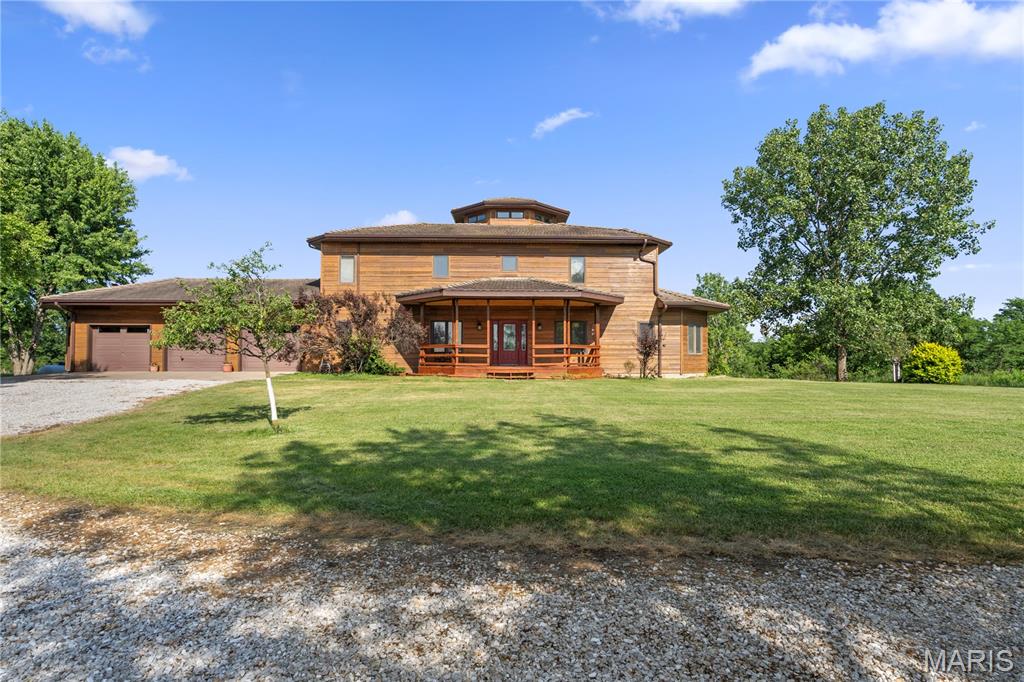 Nestled on 15 partially wooded acres just minutes from Kirksville, Missouri, this stunning home exudes a unique southwest flair. The custom-designed cedar-sided residence showcases meticulous craftsmanship, highlighted by two-story vaulted ceilings that create an inviting atmosphere. Throughout the home, octagonal spaces and wood beams add architectural interest, while an open hand-cut spiral staircase serves as a striking focal point.
Inside, the layout features a spacious living area, a private dining room for intimate gatherings, and a dedicated office space, perfect for remote work or study. The high-end kitchen is a culinary enthusiast's dream, boasting maple countertops and top-of-the-line sub-zero appliances, including a built-in refrigerator and freezer. This thoughtful design ensures both functionality and elegance in everyday living.
The outdoor spaces are equally impressive, featuring a wraparound deck that provides stunning views of the natural landscape. A shared pond adds a tranquil element, perfect for relaxing or enjoying recreational activities. The property also includes a spacious 3-car garage, offering ample storage and parking options, along with a full unfinished walk-out basement that presents opportunities for customization and expansion.
This home is a harmonious blend of luxury and nature, making it an ideal hunting retreat or family residence.