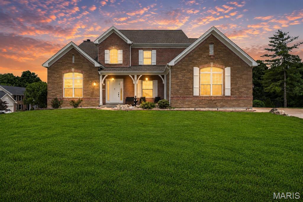 Welcome to luxury living in the heart of Wildwood! Nestled on a beautifully landscaped lot in the highly sought-after Rockwood School District, this impressive 4-bedroom, 4.5-bath home offers nearly 4,000 sq ft of refined living space above grade, plus a partially finished walk-out lower level designed for both everyday comfort and effortless entertaining. A dramatic two-story foyer welcomes you inside, where soaring ceilings, rich hardwood floors, crown molding, custom built-ins, and abundant natural light create an elegant yet inviting atmosphere. The expansive kitchen is truly the heart of the home, featuring custom cabinetry, granite countertops, a center island, breakfast bar, stainless steel appliances, and a bright breakfast room overlooking the backyard. The spacious family room offers a cozy fireplace and seamless flow into the surrounding living spaces, making it ideal for gatherings of any size. Upstairs, the luxurious primary suite serves as a private retreat with tray ceilings, a spa-inspired bath featuring a soaking tub, separate shower, double vanity, and an oversized walk-in closet. Generously sized secondary bedrooms provide ample space for family and guests, while the fully finished walk-out lower level offers additional living space, a sleeping area, full bath, and endless possibilities for recreation, fitness, or entertaining. Step outside and discover your own backyard oasis complete with a private in-ground pool, expansive deck, hot tub, and beautifully maintained yard perfect for summer gatherings or peaceful evenings at home. Additional highlights include main-floor laundry, a 3-car side-entry garage, and a prime location near shopping, dining, parks, and major commuter routes. This exceptional home offers the perfect blend of elegance, space, and resort-style living.