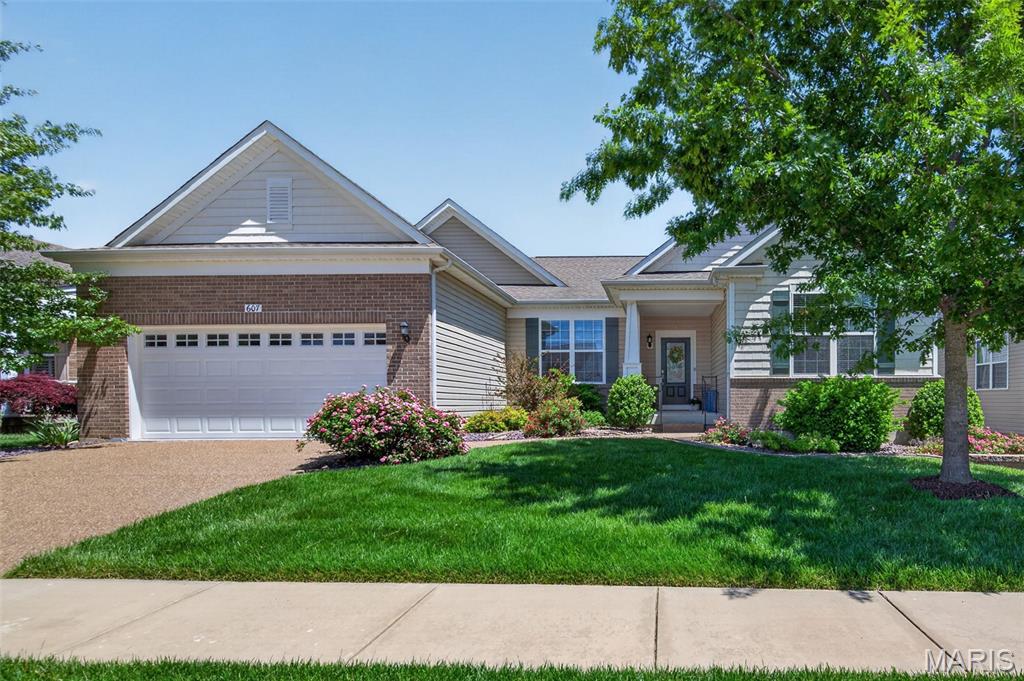 Enjoy easy, low-maintenance, luxury living in the sought-after Heritage of Hawk Ridge 55+ gated community. Built by Pulte Homes in 2015, this beautifully maintained Reflection model offers 2,450 sq. ft. of comfortable single-level living with 2 bedrooms, 2.5 bathrooms and flexible space for a potential 3rd bedroom. This detached home features stone and brick accents, maintenance-free vinyl siding, aggregate driveway, covered front porch, composite rear deck, irrigation system and level backyard. Inside, you’ll find 9-foot ceilings, luxury vinyl plank flooring, abundant natural light, gas fireplace and a spacious open floor plan ideal for everyday living and entertaining. The gourmet kitchen includes a gas range, stainless steel appliances, walk-in pantry, upgraded cabinetry, contemporary lighting and refrigerator (included). The spacious primary suite overlooks the maturely landscaped backyard and features a large walk-in closet, dual sinks, soaking tub and separate shower. A private guest suite with ensuite full bath offers comfort for visitors, while the office/sitting area and separate sewing/craft room provide flexible living space, with potential for a 3rd bedroom if a closet is added. The unfinished lower level offers excellent storage and future living space potential with an egress window and rough-in for a full bath. Additional features include main-floor laundry with utility sink, washer and dryer (included), upgraded blinds and dual electrical panels. Monthly fee includes lawn care, snow removal, clubhouse, pool, tennis, gated entrance and numerous social activities. Residents also enjoy the beautifully maintained executive par-3 golf course and vibrant Heritage of Hawk Ridge lifestyle.