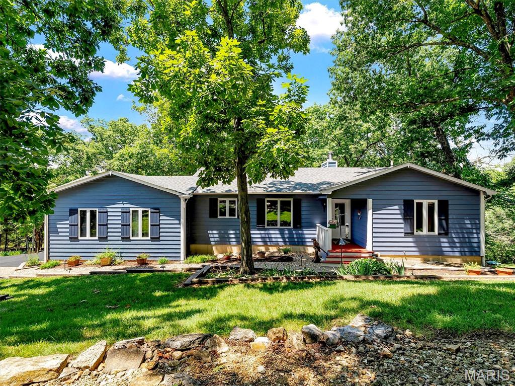 Welcome home to 19 Summit Lane, where breathtaking wooded views, thoughtful updates, and an exceptional location come together in one of the area's most sought-after neighborhoods. Nestled in the Lakewood Hills community and located within the award-winning Rockwood School District, this home also enjoys the advantage of Jefferson County property taxes, offering an outstanding combination of quality schools and long-term value.

Designed for today's lifestyle, this spacious ranch home welcomes you with beautiful curb appeal, mature landscaping, and truly serene setting. The moment you step inside, your eyes are drawn through the wall of windows overlooking the peaceful forest beyond—a stunning first impression that makes this home truly unforgettable. The open-concept floor plan is ideal for both everyday living and entertaining, featuring a formal dining room and a light-filled great room anchored by a warm wood-burning fireplace. Step onto the elevated deck to enjoy your morning coffee while surrounded by nature, creating the feeling of a private treehouse retreat.

The heart of the home is the beautifully remodeled custom kitchen, complete with a large center island, solid surface countertops, abundant cabinetry, and a distinctive sliding pantry door that blends style with functionality. Whether preparing family dinners or hosting friends, this space was designed to bring people together.

The main-floor primary suite provides the convenience buyers are searching for, offering generous closet space and a private ensuite bath. The finished walk-out lower level creates exceptional flexibility with two additional bedrooms, two full bathrooms, a spacious recreation room, a dedicated home office, and a large laundry room with abundant storage. Walk outside to the lower deck and enjoy a private backyard surrounded by mature trees, complete with a charming treehouse and swing set that make this property just as enjoyable outdoors as it is inside.

Major improvements provide confidence for years to come, including a NEW ROOF installed July 2026, water heater (2025), main-level windows (2024), front door and garage door (2022), water softener (2020), lower-level windows (2018), remodeled kitchen and half bath (2017), HVAC system (2016), well pressure tank (2016), and driveway resurfacing (2014).

Life in Lakewood Hills means more than just owning a beautiful home, it is also a dedicated bird and game sanctuary. Residents enjoy a private beach and lake for fishing and kayaking, scenic walking trails, and neighborhood events throughout the year. With easy access to downtown Eureka for shopping, restaurants, parks, and major highways, you'll enjoy the perfect balance of peaceful living and everyday convenience.

If you've been searching for a move-in ready home in the Rockwood School District, with main-level living, wooded privacy, modern updates, and outstanding community amenities, 19 Summit Lane is the place you've been waiting to call home. Schedule your private tour today and experience why this remarkable property stands apart from the rest.