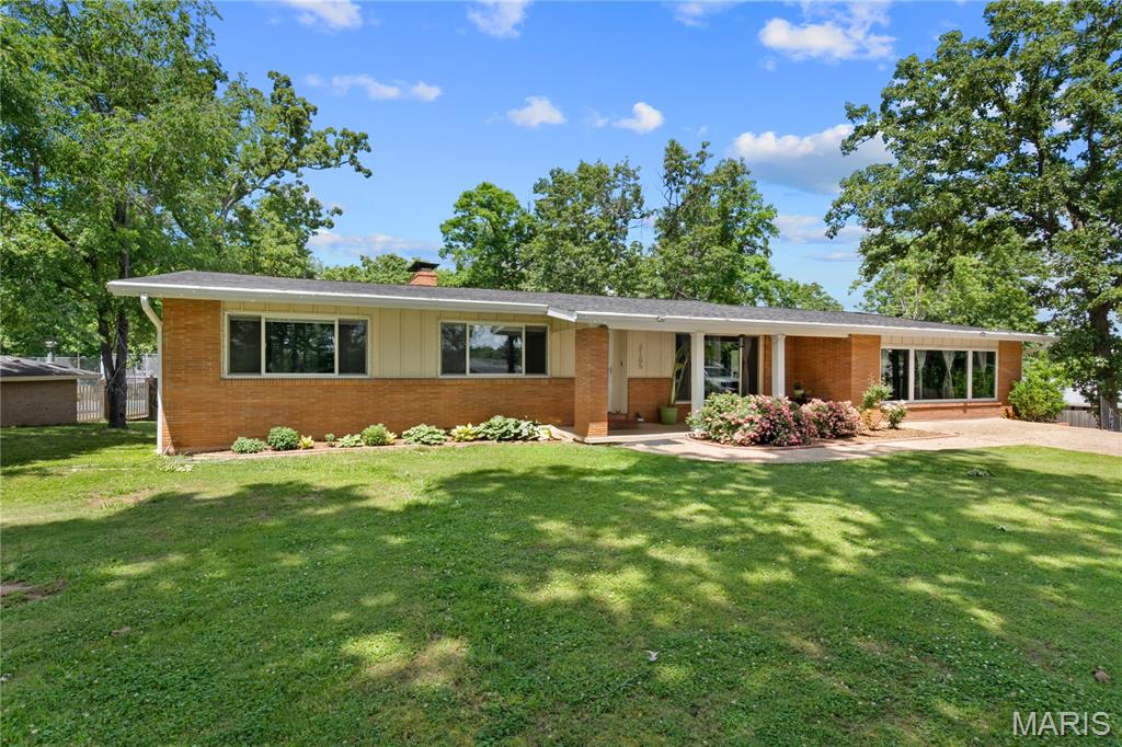 2022 Remodel!! 4BR/4BA home in the desirable Haven Hills subdivision, centrally located in the heart of Poplar Bluff. Features include contemporary designed upgrades with lots of tile, glass, and stainless appliances, durable 3/4" hardwood floors, quartz kitchen countertops, keyless entry locks, stone veneer accent wall and fireplace. Newer mechanicals include new dual fuel heat pump system with natural gas backup, zoned mini-split system, all new PEX water supply lines and pvc waste lines, 200 Amp underground electrical service, new natural gas piping, insulated Low E windows and a tankless hot water system. 2025 upgrades include new roof, landscaping, and retaining wall.  Don't miss this one! Playground stays with home.