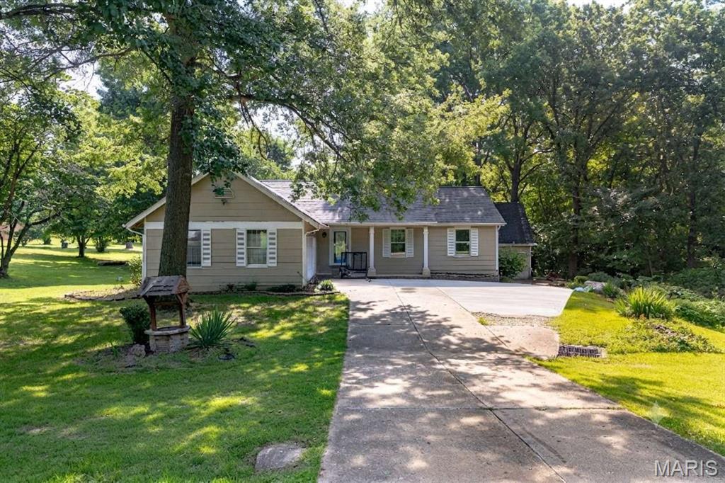 This great home sits on 3 big, beautiful acres with trees and flat grass, but it is still very close to shopping and highways in O'Fallon. Inside, there are 3 bedrooms and 2.5 bathrooms, plus a big living room and a finished basement room for games. There is a cool indoor room with a big hot tub, and a nice two-tier deck outside to sit and relax. It has two big garages for four cars and tools. Best of all, it has a brand-new roof, a brand-new water heater, a new water softener, and a very good heater that is only three years old. It uses its own clean well water and a private tank for waste. The neighborhood fee is very cheap, and it is close to nice parks and fun places to play! This will not last!!