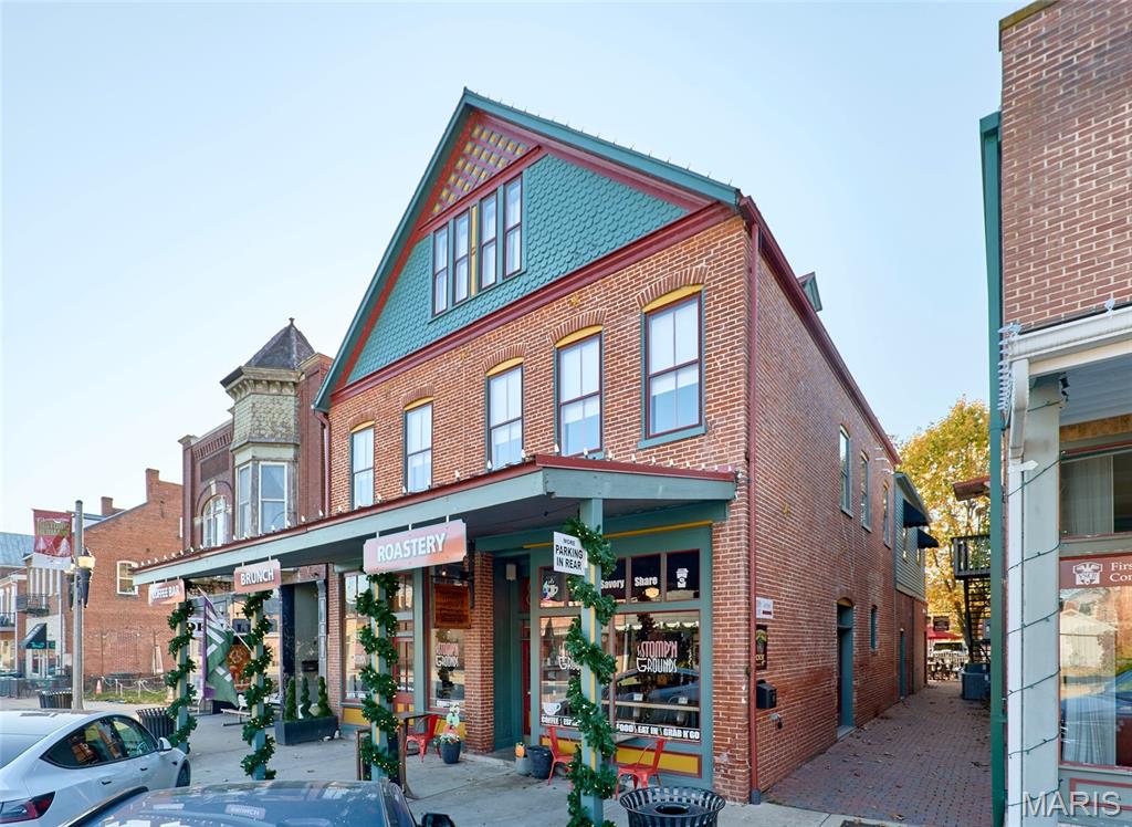 214 E 1st Street is situated directly on Hermann’s main drag, and this property offers a rare opportunity to purchase an impeccable building along with the fully operational Stomp’n Grounds Espresso Bar and Half Corked Inn guest suites, all in the heart of one of Missouri’s most visited and admired communities. Commonly crowned as “Missouri’s Most Beautiful Town,” 214 E 1st Street sits in the center of Hermann’s primary commercial corridor, steps from wineries, breweries, restaurants, shops, trolley service, and the Amtrak station. The 3-story, 4,800 sq ft building is exceptionally well maintained, with updated mechanical systems and modernized interiors, while still cherishing the historic quality and character of this impressive property. From the massive picture windows in the cafe, the solid brick construction, reclaimed floors, and beautiful renovations, to the high-end cafe, fixtures, organized service areas, and welcoming courtyard, continued investment and care stand out at every turn.

The ground floor is home to Stomp’n Grounds Espresso Bar, an anchor of Hermann and a fully functioning cafe business included in the sale. The cafe interior is clean, modern, and thoughtfully laid out, featuring quality in everything from the newer LaMarzocco espresso machine, Simonelli espresso grinders, on-site coffee roaster, copper counters, stainless commercial-grade kitchen equipment, and welcoming seating areas, and a beautiful patio that makes for a great customer experience and efficient investment. The brand has an established following, supported by its strong street visibility, consistent tourist foot traffic, and online presence. Stomp’n Grounds operates with full-time employees and defined operational systems, allowing the business to run without an owner needing to handle day-to-day oversight. The business conveys with its equipment, inventories, menu infrastructure, POS, branding, online presence, and all components necessary for a seamless transition. The seller will assist in the transition and training of new owners.

Half Corked Inn consists of two short-term rentals above the cafe. Silver Moon Loft is a cozy, private short-term rental with a warm, comfortable atmosphere and an efficient, welcoming layout. The loft includes a fully equipped kitchen, dining room, a well-appointed bedroom, an upgraded bathroom, a fireplace, a smart TV, a washer/dryer, and everything guests would need. Guests enjoy access to the courtyard and firepit, along with breakfast coupons for the cafe below, which provide convenience and enhance their overall experience.

The neighboring Harvest Hills Loft is a 2-story, larger short-term rental designed for groups, featuring three bedrooms. Two full bathrooms and a private washer/dryer make the space practical for larger groups, and the open living area includes a fireplace, smart TV, and a comfortable seating layout. The kitchen is fully equipped with essentials for longer stays, and a private desk and reading area provide guests with a quiet place to work or relax. The private balcony overlooks the courtyard, creating a peaceful spot and room to spread out. The unit is clean, well arranged, and stocked with coffee, tea, and bottled water, along with breakfast coupons for Stomp’n Grounds. With nearly 500 5-Star reviews and future reservations already booked, these units are an easy transition with immediate cash flow for the next owner.

Taken together, 214 E 1st Street represents a truly turn-key investment with multiple established revenue streams. The cafe is staffed and operates efficiently, while the two short-term rentals are furnished & functioning. The building’s location and income potential make it a standout property.  This offering provides immediate operational continuity and the ability to benefit from Hermann’s year-round visitor traffic without requiring renovation or staffing changes.

This is a duplicate listing to MLS #25079518.
