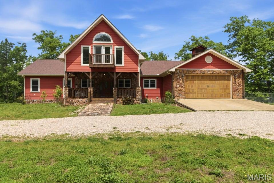 Situated along the crystal-clear waters of the legendary Jacks Fork River, this extraordinary gated estate offers approximately 11 acres of premier riverfront property surrounded by the breathtaking beauty of the Missouri Ozarks. With stunning river views, mature timber, and exceptional privacy, this one-of-a-kind retreat perfectly blends luxury living with outdoor adventure. The custom-built home features 6 bedrooms total, including 1 non-conforming bedroom, and offers an expansive layout designed for entertaining, family gatherings, or multi-generational living. The main level welcomes you with soaring ceilings, abundant natural light, spacious living areas, and warm rustic finishes that complement the natural surroundings. The kitchen flows seamlessly into the dining and gathering spaces, while the attached 2-car garage and main-level laundry provide everyday convenience. Above the main level, a spacious loft overlooks the living area below and offers endless possibilities for a game room, office, bunk area, or additional lounge space. The fully finished walkout basement expands the living space even further with a separate kitchen, large family room, full bath, utility room, and 3 bedrooms, creating excellent guest accommodations or vacation rental potential. Outside, a gated entrance and winding drive lead through the trees to the beautifully positioned home overlooking the river. Enjoy direct access to the Jacks Fork River along with endless opportunities for floating, kayaking, fishing, swimming, and enjoying the peaceful Ozark scenery. Whether you're searching for a luxury private residence, family retreat, or investment opportunity, this remarkable property offers an unmatched combination of elegance, privacy, and recreation. Separate tracks available. Contact listing agent.