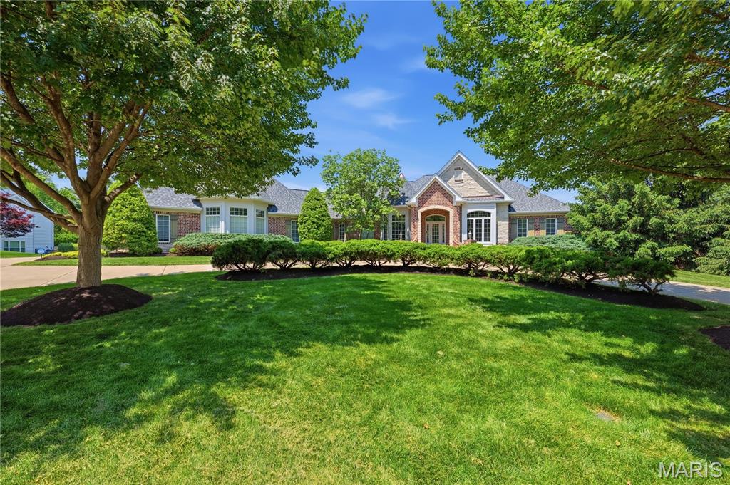 Some homes are built. This one was crafted.

238 Cornwall Drive is a sprawling ranch set on a private acre in Camelot, one of St. Charles County's most coveted addresses. With 3,188 square feet above grade and 5,142 square feet of total finished living area across two levels, this home delivers far more than the search filter reveals.

Professionally designed landscaping frames a brick and stone exterior. An HOA-owned lot to the right provides permanent privacy that cannot be developed. Inside, 11-foot ceilings and an open floorplan greet you with new LVP flooring throughout the foyer, living room, dining room and main hallway. A wall of arched transom windows frames the backyard like a painting.

Three fireplaces — two on the main level, one on the lower level.

The kitchen features a 6-burner commercial-grade range beneath a custom carved statement hood, fully integrated appliance suite, granite countertops, custom cabinetry, and a large center island. The private study offers coffered ceilings and custom cherry built-ins. The formal dining room with detailed tray ceiling seats ten comfortably. The primary suite includes a spa-caliber bath with jetted tub, dual vanities, and two custom walk-in closets.

The walkout lower level is finished to the same standard as the main floor and opens through a dramatic arched colonnade into a great room with stone fireplace. The bar features two temperature-controlled wine centers — one for reds, one for whites — a built-in ice maker, fully integrated microwave, and a frame-style TV built into the bar.

Additional features: new roof and gutters, new HVAC in 2023, EV charger, whole-home Sonos-compatible audio with outdoor zones on both the patio and deck, smart home security system, smart thermostats, landscape lighting, and epoxy-finished oversized garage.

Listing agent is the owner of this property and a licensed REALTOR in the State of Missouri.