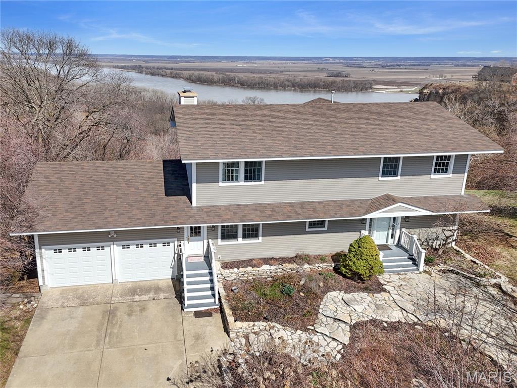 BACK ON THE MARKET - now offering seller's financing!
Perched high above the Mississippi River, this stunning 3,340 sq ft home offers breathtaking panoramic views and a setting that is truly one of a kind. Situated on a full acre, the property provides privacy, space, and incredible scenery that can be enjoyed from nearly every level of the home. Inside, the residence features 4 bedrooms and 4 bathrooms with spacious living areas designed to take full advantage of the surrounding landscape. Large windows throughout the home frame sweeping river views, filling the interior with natural light and creating an ever-changing backdrop. The main living spaces feature beautiful hardwood flooring and two impressive stone fireplaces that add warmth  and character. The kitchen offers abundant cabinetry and counter space while flowing seamlessly into the surrounding living and dining areas—ideal for both everyday living and entertaining. 
Step outside to enjoy multiple outdoor living spaces, including a massive deck and a screened-in porch, perfect for relaxing while overlooking the river valley. Whether hosting gatherings or enjoying quiet mornings with coffee, the views from this home are truly unmatched. With generous square footage, timeless features, and one of the most remarkable Mississippi River overlooks in the area, this property presents a rare opportunity to own a home where the scenery becomes part of everyday living. Call for your private tour today!