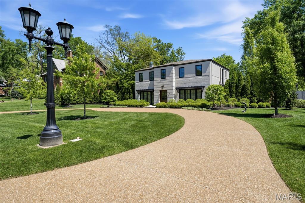 Welcome to this beautifully updated 4 bed, 3.5 bath home in sought-after La Hacienda Neighborhood in Ladue. The current owners have meticulously maintained the property and enhanced it with upgraded kitchen appliances, new carpeting, a whole-house generator, and more—making it truly move-in ready. Stunning curb appeal features handsomely painted brick, 2 front patios, elegant landscaping and out back a charming private patio with enough yard for playtime or future pool possibilites. Inside, the spacious kitchen and baths offer timeless custom cabinetry, extended center island for your culinary creations, and the perfect breakfast room for everyday dining. Open the glass sliders in the dining and family rooms to create your own vacation, indoor-outdoor entertainment space.  Wow!  Upstairs highlights include a light and spacious primary suite with jetted tub, walk in closet with custom built ins.  Two additional bedrooms, updated hall bath, and 2nd bedroom suite will check all your boxes.  Heated floors on both levels is a rare find and a delight during cooler months.  Main floor laundry & storage, attached 2-car garage, and access to Price Rd. via private electric gate are just some of the bells and whistles.  Never worry about your basement flooding again with this solidly constructed slab residence.  Schedule your appointment to come see for yourself, you won't be disappointed.