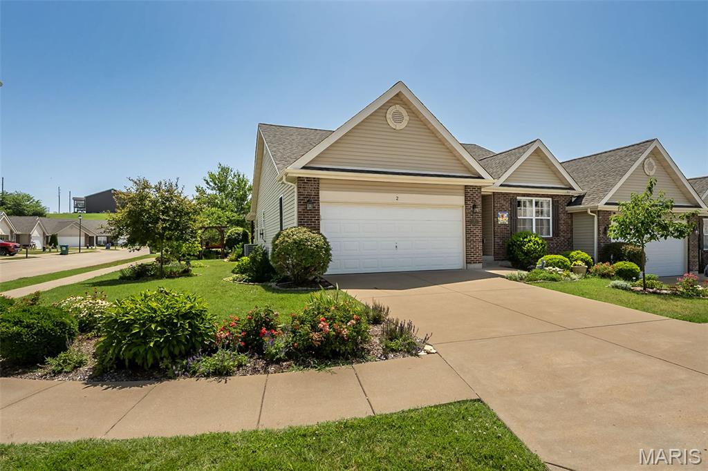 Beautifully maintained and thoughtfully upgraded, this exceptional villa offers the perfect blend of comfort, convenience, and carefree living. Featuring over 2,200 square feet of finished living space, this 2-bedroom, 3-bath home is designed for those who want room to spread out without the maintenance of a large yard. Rich ash hardwood flooring flows throughout the main living areas and into the spacious primary suite, while soaring vaulted ceilings create an open, inviting atmosphere perfect for everyday living and entertaining.

The bright eat-in kitchen offers abundant cabinetry, generous workspace, stainless steel appliances, an induction range, and easy access to the adjacent breakfast room. The vaulted great room opens to a covered patio overlooking beautifully designed gardens, decorative paver walkways, and professionally landscaped grounds enhanced by an irrigation system—creating your own private botanical retreat.

The spacious primary suite features hardwood flooring, a generous walk-in closet, and an en-suite bath, while a second bedroom, full bath, and convenient main-floor laundry complete the main level.

The beautifully finished lower level expands your living space with a large recreation room, bonus room ideal for a home office, hobby room or guest space, an additional full bath, plus an abundance of unfinished storage.

Enjoy added peace of mind with the included Goal Zero whole-house battery backup generator system with solar charging capability, providing backup power during outages. Additional highlights include an attached two-car garage, decorative electric fireplace, and numerous thoughtful upgrades throughout.

Perfectly situated in a charming, walkable community just minutes from shopping, dining, medical facilities, schools, and convenient highway access, this location offers the ideal balance of peaceful living and everyday convenience.

Whether you're downsizing, simplifying, or simply ready to enjoy more of life's moments, this thoughtfully designed villa offers comfort, convenience, and a lifestyle you'll love coming home to.