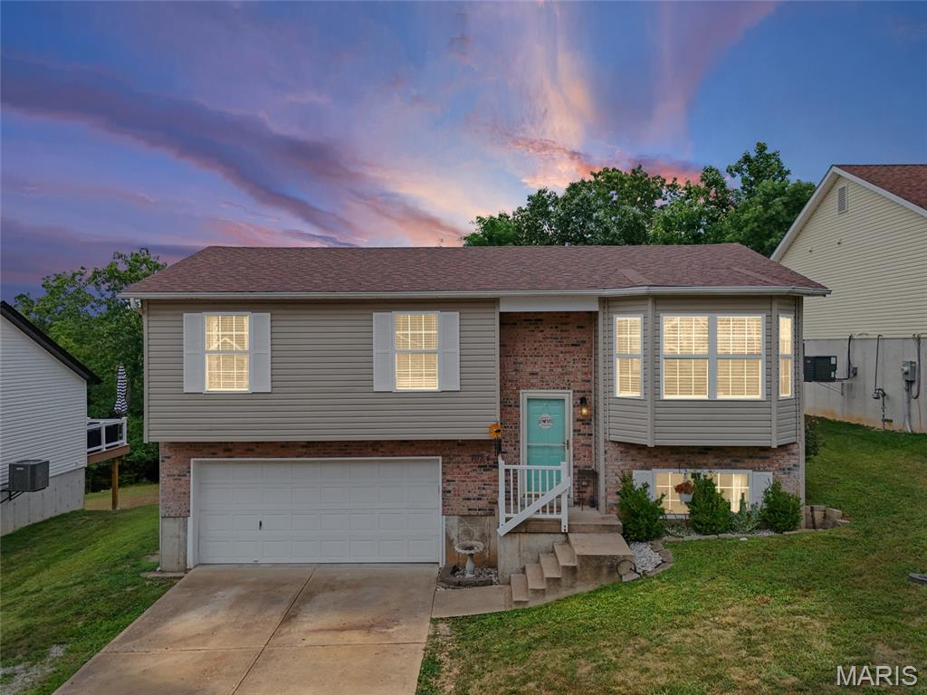 Welcome home to this charming 3-bedroom, 1-bath home with a 2-car garage offers an inviting open floor plan designed for comfortable everyday living. The spacious living area features vaulted ceilings and beautiful hardwood floors, creating a bright and airy atmosphere throughout. The kitchen is equipped with stainless steel appliances, a center island perfect for meal prep or casual dining, and plenty of storage to keep everything organized. The finished recreation room in the basement provides flexible living space and can easily serve as a fourth bedroom, home office, fitness room, or entertainment area. Step outside onto the back deck and take in the peaceful wooded views. The backyard offers the perfect setting for entertaining, summer barbecues, gardening, or simply relaxing in your own outdoor retreat. Conveniently located and full of versatile living space, this home is ready for its next owner. Schedule your private showing today!