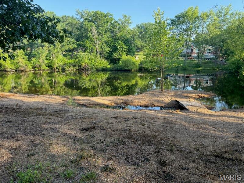 Discover a rare opportunity to own not just one, but three beautiful lots being offered together located in Lake St Clair subdivision with mature Oak Trees, huge private beach and island with bridges. Adjoins common ground with second lake just across the spillway creek.  Lake St. Clair is a private, Franklin County, Missouri community and is located approximately 1 mile west of the City of St. Clair, Missouri off of Missouri Highway PP.  Developed in the early 60’s by Authorized Investors Group the community consists of 450 acres of land, with 1352 lots and twenty three miles of road.  The highlight of the community are the four lakes found within the subdivision.

 The main lake, Lake #1, covers approximately 60 acres and is used primarily for recreation such as boating, skiing, fishing and other water sports.  At one end of Lake #1 is a marina and boat launch.  At the other end of Lake #1 you will find a public beach for non-waterfront owner’s use.  Lakes 2, 3, and 4 also are used for recreational purposes however only trolling type motors are allowed on these three lakes.  

Whether you're dreaming of building your custom waterfront home with private beach and island creating a private family retreat, or investing in future development, these lots provide endless possibilities. Enjoy stunning water views, direct lake access with second one next door, and plenty of space for your ideal home, outdoor living areas, and recreational activities. Fish, kayak, swim, or simply relax and take in the peaceful surroundings. With three combined lots, you'll have added privacy, flexibility, and room to bring your vision to life. There is a shed with wired electric ready as well as a bridge connecting lots to adjoining common ground with access to neighboring lake. Don't miss this unique chance to secure your own slice of waterfront paradise with an island!  There are no electric, water or sewer utilities on the property but nearby.

In the 80's the subdivision received a federal-state grant to install and operate a sewer district.  Along with the Franklin Count Water Company and Ameren Missouri the subdivision has full infrastructure in place to support the 322 homes that are now within the community. Property owners also pay a sewer assessment levied by the Lake St Clair Sewer District.  Property owners desiring access to water have an option of drilling a well or contracting with the Liberty Water company. The development is managed by five trustees, who are elected by those property owners. Yearly assessments.