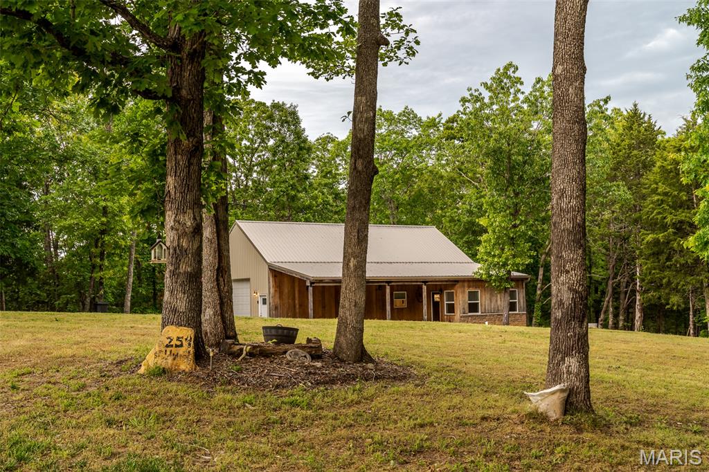 Beautiful, custom home, 9.9 acres, and only 10 minutes from Union! Like NEW! Stunning kitchen, custom cabinets, cozy layout, attention to detail throughout! Primary bedroom and bathroom located on main floor. 2 large bedrooms, full bath, and ample storage. The oversized garage was being used as a rec room/man cave featuring a wood burning fireplace! Would make a great shop too! 400 amp electric service offers room to grow! Welcoming front porch it lined with charming White Oak panels. It's extra living space outdoors! Mature trees, HUGE yard, and 4-wheeler/golf cart trails are every country lovers dream! If you have been waiting to find the perfect spot for your "Barndominium", THIS IS IT! And it's move in ready!!! Set up your private tour TODAY!