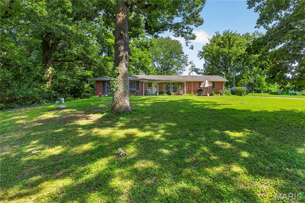 Welcome to this charming ranch-style home situated on a spacious 1.08-acre lot in Bellefont Neighborhood! This 3-bedroom, 1.5-bath home offers 1,290 sq. ft. of comfortable single-level living with a functional layout that includes a bright living room, a cozy family room with a fireplace, and an eat-in kitchen. Hardwood flooring adds warmth throughout much of the home, while the full basement provides excellent storage or future finishing potential. A detached 2-car garage, expansive backyard, and mature trees create the perfect setting for outdoor entertaining, gardening, or simply enjoying the extra space. Conveniently located with easy access to major roads, shopping, dining, and local amenities, this property offers a rare combination of privacy, usable acreage, and everyday convenience. Don't miss this opportunity to make it your own!