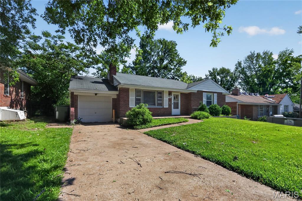 Welcome home to this classic all-brick ranch situated in the heart of Bellefontaine Neighbors! Boasting exceptional curb appeal with full brick construction on all four sides, this move-in ready 1950s gem offers the perfect blend of mid-century durability and functional single-story living. Step inside to discover a bright and spacious living room featuring large insulated windows that flood the home with natural light, showcasing beautiful original hardwood floors that flow seamlessly throughout the main level. The floor plan efficiently layout features 3 comfortable bedrooms, including a main floor primary suite equipped with its own private half-bath. The kitchen functions perfectly as an eat-in space with a practical layout and built-in pantry storage. Need more space? The expansive, full concrete basement matches the entire main floor footprint and features a standard sump pump and laundry hookups - offering a completely blank canvas ready for your custom finishing ideas, a home gym, or a massive workshop. Step out the back to a level yard with a concrete patio pad, ideal for summer barbecues, outdoor entertaining, or pets.
