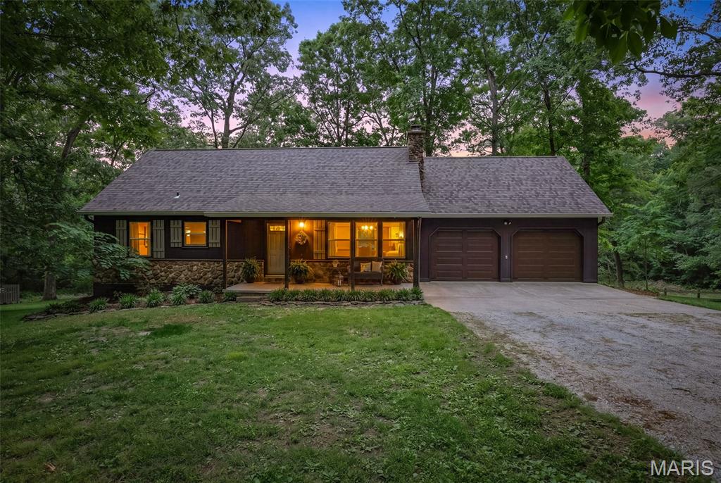 Slow down and take a look at this peaceful property with over 20 secluded acres just off I-55. Nestled through the woods down a gravel road is a meticulously maintained home with an attached garage, full basement, and small barn ready for horses or a hobby farm. This home boasts vaulted ceilings, open-concept living area, a floor to ceiling natural stone fireplace, 2 main floor bedrooms with one having access to the deck, full bathroom, loft area, and partially finished basement. The basement offers a laundry room, workshop/flex space, and den with plenty of space for entertaining that walks onto the back patio. The attached two-car garage has a staircase leading up to a large storage area with potential for a finished area or flex space. The garage leads onto the deck and into the dining area. Enjoy gathering on the deck, take in the park-like views and be completely surrounded by nature and even your own hobby farm or oversized garden. Full of endless possibilities, this property is a rare find in a convenient location!