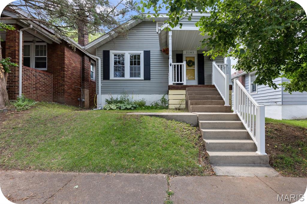 ** Open House Sunday 1-3 PM ** Welcome to Esther Ave, your cottagecore dream home with modern touches throughout. From the moment you step inside, you’ll notice how every inch of the floor plan is thoughtfully maximized to live comfortably and efficiently. Natural hardwood floors, updated windows, and an open main level create a space that feels much larger than expected. The living room flows effortlessly into the kitchen, while a separate dining area offers the perfect balance of openness and defined space. The kitchen features stainless steel appliances, added storage and prep space, and just off the back door is easy access to a spacious deck—perfect for morning coffee or dining al fresco. New lighting throughout adds a fresh, modern touch. 

Two beautiful French doors lead to the first bedroom, complete with a mirrored double-closet and great natural light. Down the hall, you’ll find a refreshed full bathroom with a shower, full tub & ample linen storage. The second bedroom overlooks the backyard and offers peaceful views, along with a fun surprise—one of the “closets” opens to a hidden passage leading to the finished attic. This bonus space is currently used as a playroom but would also make a great studio, storage area, or cozy retreat. The sellers are including the AC unit to keep it comfortable year-round. The lower level features an exceptionally tall basement with a practical water closet—nothing too fancy, but incredibly convenient when the main bathroom is in use. Out back, enjoy your own green space with planters hanging from the garage and plenty of room to start a garden. Off-street parking includes a garage and parking pad with space for two cars. 

2161 Esther Ave offers a prime location just two blocks from Clifton Heights Park—one of St. Louis’ most unique and picturesque green spaces. Known for its rolling topography (a rarity in the city), the park features winding streets, a charming lake with ducks and geese, fountains, and scenic overlooks. With easy access to Hampton Avenue and Highways 44 and 64, this is a dreamy cottage in the heart of the city—while still feeling tucked into nature. Schedule a tour with your favorite Realtor this week or stop by the open house Sunday from 1–3 PM to see all that Esther has to offer!