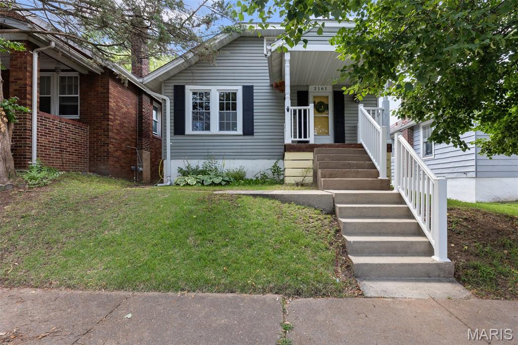 ** Open House Sunday 1-3 PM ** Welcome to Esther Ave, your cottagecore dream home with modern touches throughout. From the moment you step inside, you’ll notice how every inch of the floor plan is thoughtfully maximized to live comfortably and efficiently. Natural hardwood floors, updated windows, and an open main level create a space that feels much larger than expected. The living room flows effortlessly into the kitchen, while a separate dining area offers the perfect balance of openness and defined space. The kitchen features stainless steel appliances, added storage and prep space, and just off the back door is easy access to a spacious deck—perfect for morning coffee or dining al fresco. New lighting throughout adds a fresh, modern touch. 

Two beautiful French doors lead to the first bedroom, complete with a mirrored double-closet and great natural light. Down the hall, you’ll find a refreshed full bathroom with a shower, full tub & ample linen storage. The second bedroom overlooks the backyard and offers peaceful views, along with a fun surprise—one of the “closets” opens to a hidden passage leading to the finished attic. This bonus space is currently used as a playroom but would also make a great studio, storage area, or cozy retreat. The sellers are including the AC unit to keep it comfortable year-round. The lower level features an exceptionally tall basement with a practical water closet—nothing too fancy, but incredibly convenient when the main bathroom is in use. Out back, enjoy your own green space with planters hanging from the garage and plenty of room to start a garden. Off-street parking includes a garage and parking pad with space for two cars. 

2161 Esther Ave offers a prime location just two blocks from Clifton Heights Park—one of St. Louis’ most unique and picturesque green spaces. Known for its rolling topography (a rarity in the city), the park features winding streets, a charming lake with ducks and geese, fountains, and scenic overlooks. With easy access to Hampton Avenue and Highways 44 and 64, this is a dreamy cottage in the heart of the city—while still feeling tucked into nature. Schedule a tour with your favorite Realtor this week or stop by the open house Sunday from 1–3 PM to see all that Esther has to offer!