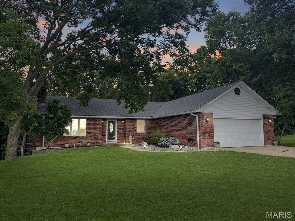 Looking for acreage close to Washington? How about a ranch home with privacy? Then look no further and submit your offer today! Just 5 minutes from Hwy 100, shopping, dining, and entertainment, this beautifully maintained ranch home sits on 10 private acres with a great balance of open ground and woods. Offering approximately 1,500 sq ft, this home features a 2-car garage, incredible updates, and a finished lower level. The formal floor plan includes an inviting entry foyer, spacious living room, open kitchen and dining area, plus a hallway leading to 3 main-floor bedrooms. In addition to being exceptionally well-cared for, recent updates include doors, flooring, fixtures, and bathroom vanities. The 10 acres+- consist of two separate 5 acre parcels, creating excellent investment and development potential. Whether you are looking for a mini-farm, private estate setting, multi-generational living opportunity, or a place to live while building your dream home, this property offers endless possibilities for a variety of unique buyer needs!