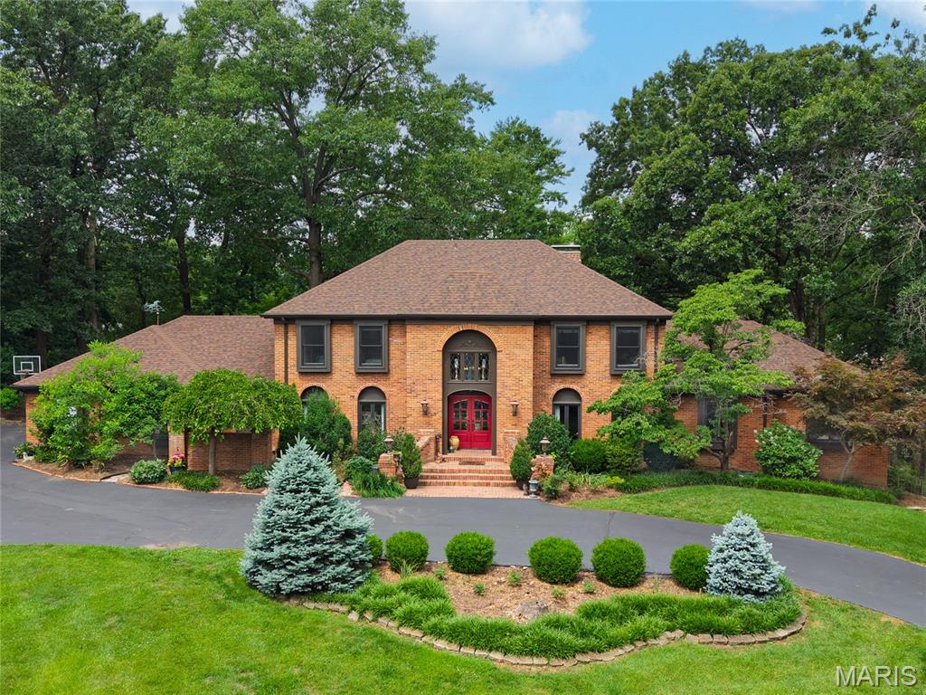Gracefully situated in the Westwood Place neighborhood and within the highly acclaimed Ladue School District,
 265 S. Graeser Rd. presents a rare opportunity to own a residence of exceptional character and distinction. With five bedrooms and five bathrooms, this beautiful home offers an unparalleled blend of elegance and comfort.  
A curved staircase creates a striking focal point upon entry. The thoughtfully designed living space provides both an open atmosphere and private workspace. The charming Country French kitchen is both timeless and inviting, serving as the centerpiece of the home and an ideal setting for gathering and entertaining.
The main-level primary suite offers a serene retreat, complete with separate his-and-her closets. This room is an emphasis on privacy and comfort. Rich architectural details, gracious room sizes, and seamless flow define the home's exceptional design.
The expansive lower level is an entertainer's dream, featuring a custom wraparound bar, billiards area, media lounge, and abundant storage. Outdoors, a custom built pool and privacy landscaping create an oasis perfect for both quiet relaxation and memorable entertaining.
Combining timeless architecture, outstanding amenities, and a premier location within one of St. Louis' most desirable communities, 265 S. Graeser Rd. represents the perfect place to call Home.