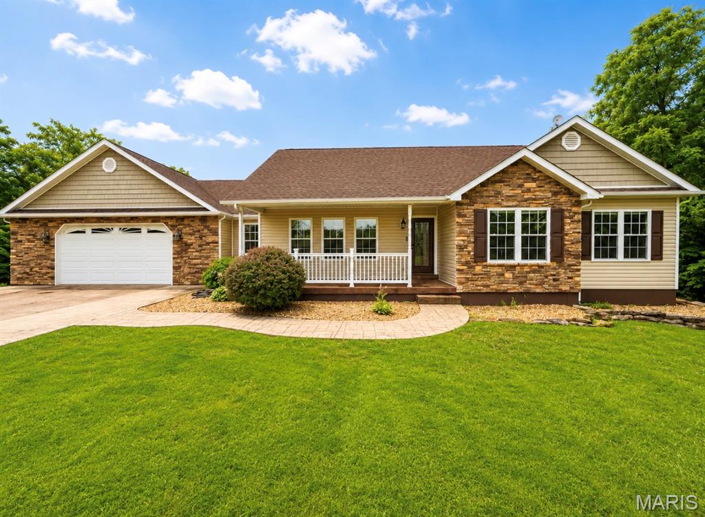 Welcome home to this stunning 3-bedroom, 2.5-bath single-story ranch offering over 3,000 square feet of living space, situated on more than 3 beautiful acres in an unincorporated setting. If you've been searching for the perfect blend of peaceful country living with modern conveniences, this property checks all the boxes! Step inside to discover an inviting open-concept floor plan that seamlessly connects the spacious living room, dining area, and beautiful country kitchen, creating the perfect space for entertaining family and friends. The main living areas feature gorgeous hardwood flooring, soaring vaulted ceilings, and an abundance of natural light that enhances the warm and welcoming atmosphere. The kitchen is truly the heart of the home, showcasing beautiful custom brickwork surrounding the stove, ample cabinetry, a spacious pantry, and plenty of countertop space for meal preparation. Best of all, the kitchen appliances are included, making your move even easier. The oversized primary suite is designed to be your own private retreat, featuring elegant coffered ceilings, a large walk-in closet, and a spacious en-suite bathroom complete with a double vanity and an walk-in shower. Two additional generously sized bedrooms provide plenty of room for family, guests, or a home office. You'll also appreciate the convenience of the spacious main-level laundry room, making everyday living both comfortable and efficient. Downstairs, the partially 3/4-finished basement offers incredible additional living space with a large recreation area, an expansive great room, and endless possibilities for entertaining, hobbies, a home gym, or future expansion. The basement also includes a fully functional bathroom with a vanity and toilet, along with existing plumbing tie-ins for a future shower, making it easy to complete to your liking. Outside, you'll fall in love with the incredible outdoor living spaces. Relax on the welcoming covered front porch, entertain on one of the two private rear decks, or enjoy gatherings on the additional backyard patio. A standout feature is the expansive custom firepit area, offering the perfect place to host family gatherings, entertain friends, or simply unwind under the stars. The spacious front and back yards provide endless opportunities for outdoor activities, gardening, kids, pets, or simply enjoying the peaceful surroundings. Additional highlights include a large attached two-car garage, bonus storge shed, private well and septic system to help reduce monthly utility costs, and over three acres of beautiful land offering privacy while still being conveniently located. Whether you're a first-time homebuyer looking for room to grow or someone ready to enjoy more space inside and out, this exceptional property offers the comfort, functionality, and country charm you've been searching for. With over 3,000 square feet of living space, spacious bedrooms, multiple outdoor entertaining areas, and an ideal blend of indoor and outdoor living, this property truly has something for everyone. Don't miss your opportunity to make this incredible home yours—schedule your private showing today!