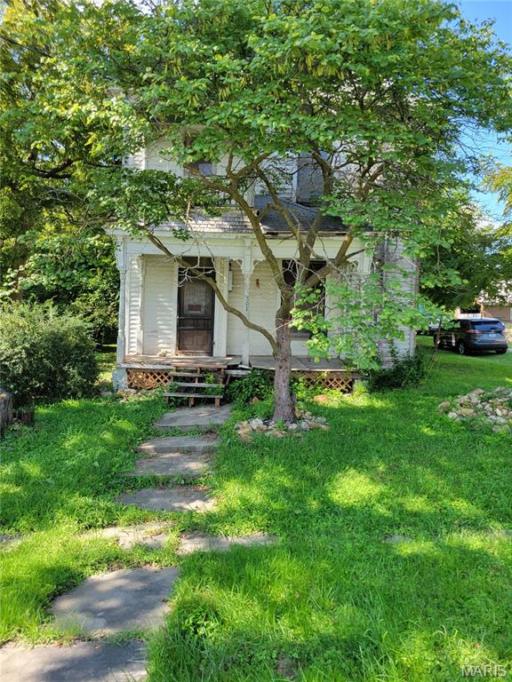 Vintage 2-sty with large rooms. Beautiful wood staircase, most rooms have 10 inch wood trim. Upstairs rooms have 9 ft ceilings and 10 ft ceilings downstairs Needs work to restore it to original beauty. Qualifies for 203k rehab loan.Large yard on 4 lots. Sold as-is.