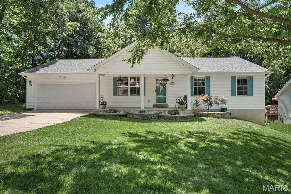 Nestled on over a half-acre lot and backing to mature trees, this spacious ranch offers the perfect combination of privacy, comfort, and functionality. Featuring 3 bedrooms and 2 full baths on the main level, this home is designed for convenient everyday living with main-floor laundry and an inviting floor plan.

The kitchen features quartz countertops and opens to the main living areas, creating a great space for gathering and entertaining. The finished walkout lower level adds valuable living space with a large family room, cozy gas fireplace, and an additional full bath—ideal for guests, a home office, recreation area, or multi-generational living.

Outside, enjoy peaceful wooded views, a spacious backyard with room to roam, and the convenience of an oversized 2-car garage with a service door for easy backyard access. With a finished walkout basement, 3 full baths, over a half-acre lot, and a desirable tree-lined setting, this O'Fallon ranch is ready to welcome you home.