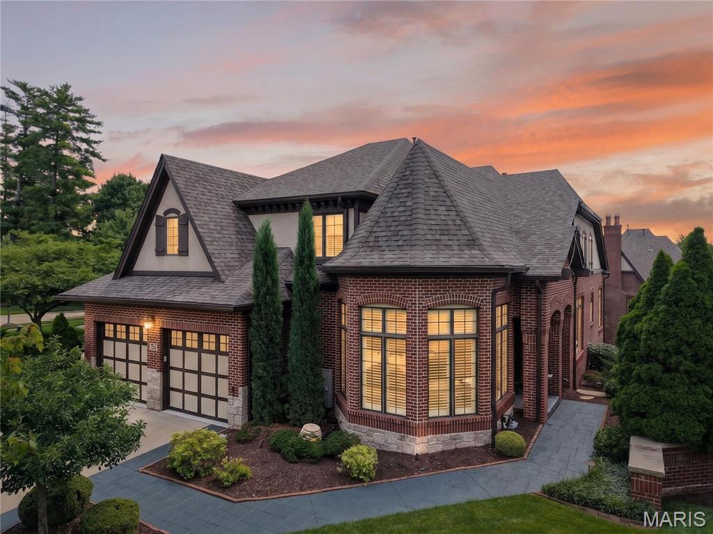 Stunning 1.5-story brick home in the highly coveted, gated community of August Hill off Conway Road. Designed for refined living and effortless entertaining, this residence blends timeless architecture with sophisticated finishes throughout.

An eye-catching reverse-vaulted great room welcomes you with rich hardwood floors and a sleek gas fireplace, flowing seamlessly into an impressive chef’s kitchen outfitted with Sub-Zero and Wolf appliances, custom cabinetry, and abundant counter space. The adjacent breakfast room offers a cozy, light-filled space that opens to a private terrace overlooking the tranquil, tree-lined backyard.

The main-floor primary suite is a serene retreat, featuring a bright bay window, hardwood floors, and a spa-inspired luxury bath with premium finishes and generous storage. Upstairs, two spacious ensuite bedrooms and an airy loft overlook the great room, providing ideal secondary living and guest spaces.

The beautifully finished lower level is designed for entertaining, showcasing a generous family room, gaming area, guest suite with full bath, and access to a screened patio for indoor-outdoor enjoyment. A full sit-down bar elevates the space, complete with custom cabinetry, dishwasher, wine refrigerator, and full-size refrigerator—perfect for hosting gatherings in style.

Offering privacy, security, and exceptional craftsmanship in one of the area’s most desirable gated enclaves, this August Hill home is a rare opportunity for the discerning buyer.

Note: **New Pella windows are on order for the entire home. **Most furnishings, excluding art collection, is negotiable.