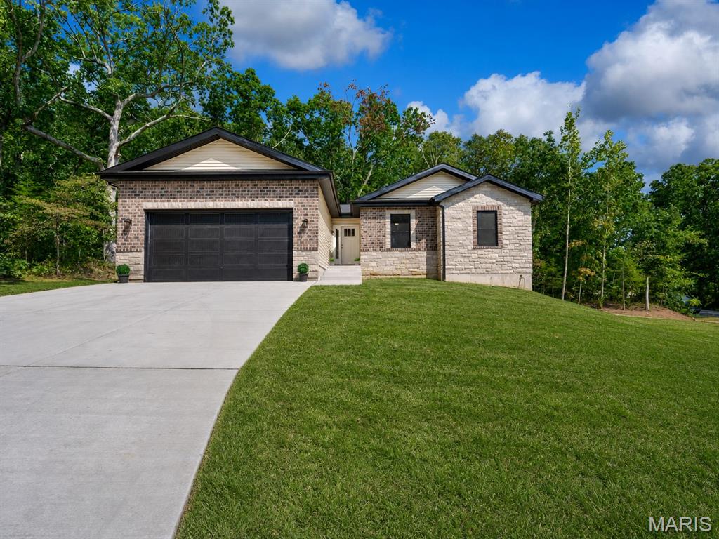 PREMIUM NEW CONSTRUCTION HOME in popular, gated Raintree Plantation lake/golf, family-friendly community!  IMPROVED! – Now with a beautifully finished walk-out lower level, adding over 1,000 SF more (total quality finished area now 2,700 SF!), Rec Room, 4th bedroom, 3rd FULL bath, LL laundry hook-up, and large storage area! Just minutes from Hwy 21 - BEAUTIFUL curb appeal with stone and brick front with covered front porch; 1,700 sq. ft on main level, vaulted ceilings, can lighting, beautiful hickory hardwood floors; neutral decor, Roman 2-panel doors throughout, tilt-in windows; kitchen with solid wood soft close white drawers/cabinets, quartz countertops, SS appliances, breakfast bar with pendant lights; main floor laundry hookup option; maintenance-free vinyl siding, private corner lot; 2x6 framing; premium insulation; side parking pad for RV or boat; 2-car attached, drywalled and insulated garage with 8-foot door height and high ceiling; large private deck backs to trees with steps down to yard - enjoy the ample wildlife!  Multiple lakes mean endless hours of summertime fun – swim, fish, golf, nature walks!  Make an appointment to tour ASAP – you’ll be glad you did!