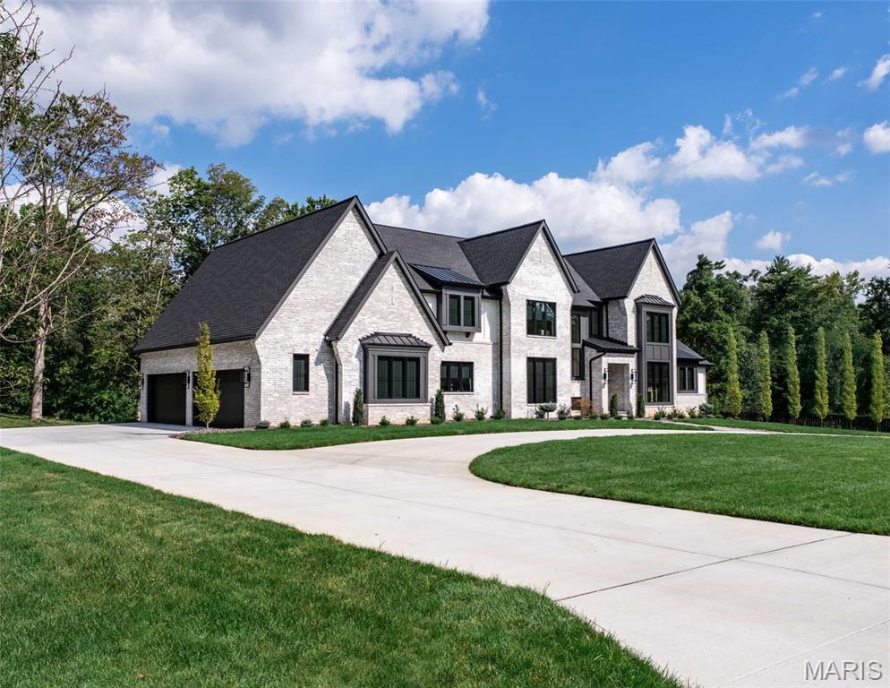 Introducing the Hawthorne II at Ballas Ridge by Kemp Signature Homes. This transitional-style residence offers nearly 5,700 sq. ft. of refined living space, designed to balance elegance with versatility. Set within Des Peres’ most exclusive new enclave of just four estate homesites (ranging from 1.59–6.5 acres), this home is tailored for modern luxury living. The soaring two-story foyer and vaulted great room create a dramatic first impression, flowing into a spacious main-floor owner’s suite with a spa-inspired bath and expansive walk-in closet. The main level highlights 10-foot ceilings, wide-plank hardwood flooring, detailed millwork, and a chef’s kitchen with premium appliances that opens to the hearth room. Outdoor living is elevated with a covered patio and fireplace, perfect for entertaining or quiet evenings. Upstairs, three ensuite bedrooms, a loft, and a convenient second laundry provide private retreats for family or guests.The optional finished lower level allows endless possibilities, including a wet bar, rec room, golf simulator, fitness studio, guest suite, or pool bath. Ballas Ridge combines unmatched privacy—rolling terrain, mature trees, and a scenic pond—with convenience to top schools, shopping, dining, hospitals, and major highways. Build with Kemp Signature Homes for a fully custom experience.