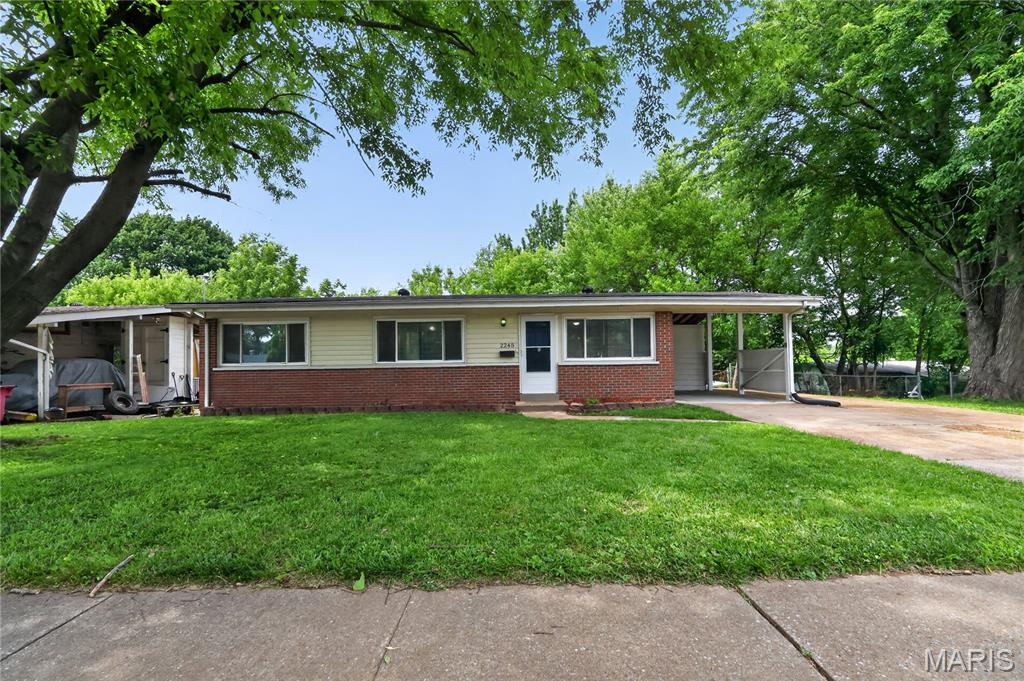 Discover classic charm in this well-maintained ranch home located in the heart of Florissant. This inviting residence features an open, flowing floor plan with three comfortable bedrooms and a full bath on the main level. The home boasts durable brick and stone construction, complemented by timeless hardwood flooring throughout the main living areas. The full basement offers expansive potential for storage or custom expansion. Outside, enjoy the convenience of a covered carport, established curb appeal, and a quiet setting with mature streetlights. Perfectly positioned near schools and amenities.