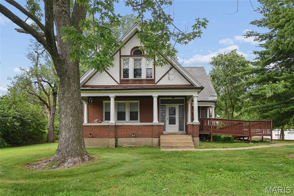 Fabulous Charming Oversized Brick Historic Home with 1 acre lot.  Covered front porch for those summer evenings drinking a cold lemonade.  Home is in wonderful condition and just ready for a family to fill it.  Abundant natural light filtrates through out the home. Upon entry into a Huge living room to have family gatherings.  Formal dining room for your holiday celebrations.  A Chef's Delight kitchen with tons of cabinetry and counterspace to create family meals.  Breakfast bar to catch a quick snack. Den for school work or managing other items.  Spacious Main Floor Primary bedroom with Double closets and room for a King sized bed.  Upstairs provides 3 more massive bedrooms and a full bath.  Back of house off the kitchen contains  an additional room for board games.  Full basement waiting for finishing.  Detached 3 car garage and storage area.  Private Panoramic view of a well maintained level 1 acre lot with Mature Trees.