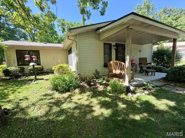 Hunters Haven. Abundant wildlife on 20 acres. This unique 2-bedroom, 1-bath home is a nature enthusiast's paradise, located right next to a beautiful, overstocked approx. 1 acre lake (where you can see the fish from the shore). The covered front porch overlooks the lake and provides a great location for relaxation.  It comes with private trails winding through the woods and a paddle boat to take on the water. The grounds are maintained with multiple flower beds, offering beauty everywhere you look. Firepit sits on the edge of the lake for great family time around the fire. This property comes with a swing, picnic table, and a screened in porch for family entertainment. Also included is a 3-car garage, with a concrete floor and a lean-to, providing space for vehicles, a workshop, or lake gear. This property is quiet, private, and would make a great home, or weekend home, for someone who loves being outside. Roof is approximately 3 years old. Open entry way would make a great location for a food plot. Diggs Conservation Area is around the corner. Callaway County Water. Fridge, microwave, stove, dishwasher, water tank, and riding lawn mower conveys with property.