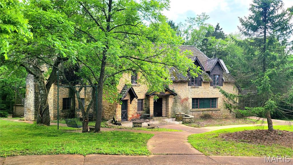 One of a kind property you won't want to miss!  If you favor French elegance, you'll love this magnificent 4-bed, 4-bath, sprawling, limestone beauty. Built with stone quarried from the property no attention to detail has been spared. Huge, sun-splashed family room is perfect for family and friends to gather. Living room features unique stone fireplace you have to see to believe!  Formal dining room is situated next to the kitchen. Love to cook? The spacious, modern kitchen, with stainless appliances, center island and more will be the place to prepare your meals. From the foyer take the gently winding staircase to the upper level and you'll be amazed by the size of the master suite! Three additional bedrooms and two full baths are housed here as well. Full walkout, partially finished basement, 2-car and 3-car detached garages. Guest house, barn w/loft and four stalls in basement, tool shop, and more. Situated on 10 peaceful, partially wooded acres. New Roof on both Houses at Closing!