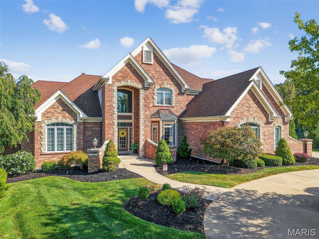 Welcome Home! Prepare to be wowed by this stately 1.5 story home that features 5 bedrooms, 7 bathrooms, a 3-car garage, and a private backyard oasis, that overlooks the 17th fairway at Lake Forest Golf Course. Upon arrival, you'll be greeted with a beautifully manicured lawn, featuring landscaping and lighting, along with the circle drive, that leads to the 9-foot double entry door which sets the tone for the home, opening to a breathtaking interior where soaring ceilings, refined architectural archways, and designer chandeliers create an immediate sense of scale and sophistication. The dramatic great room is anchored by a floor-to-ceiling stone, double-sided gas fireplace with a solid wood mantel, and a wall of windows that flood the space with natural light while framing incredible views of the private infinity pool and golf course. The primary suite offers a private escape, complete with tranquil views and a seamless connection to a richly appointed office featuring custom woodwork, built-in bookcases, and a private coffee bar with beverage cooler. The spa-inspired bath elevates daily living with an oversized soaking tub, dual vanities, water room, custom shower, and dual walk-in closets with organizers. The newly reimagined chef’s kitchen is a true showpiece, furnished with premium Café appliances: double ovens and gas cooktop, a built-in Sub-Zero refrigerator, and a grand center island with custom storage cabinetry, granite countertops, and an integrated beverage cooler. Designed for seamless entertaining, the kitchen is perfectly positioned between the breakfast room, the tucked away hearth room that features a built-in bookcase and a cozy stone fireplace with solid wood mantel, and the airy sunroom that leads to the exterior deck. On the second level, designed with both comfort and privacy in mind, the home features two ensuite guest bedrooms, each with walk-in closets, ideal for hosting. As well as a stunning loft that overlooks both the main living area and gives another perspective of the breathtaking views. The walkout lower level is an entertainer’s dream, highlighted by a striking floor-to-ceiling stone, double-sided gas fireplace and a fully equipped bar featuring a refrigerator, beverage station, kegerator and a custom-built liquor display. A dedicated wine room showcases a cellar and built-in wine refrigerator. Two more bedrooms reside in the lower level with one being an en-suite with a California Organizer walk-in closet. Step outside to a true resort-caliber hideaway. The 40,000-gallon saltwater infinity-edge Gunite pool is a masterpiece, complete with a slide, cascading waterfall, and a hidden grotto. There are plenty of opportunities to unwind with expansive outdoor living spaces that invite both relaxation and entertaining while listening to the integrated sound system that free flows from the interior to the exterior, creating an immersive experience for any occasion. This is more than a home; this stunning residence delivers an unmatched blend of sophistication, comfort, and elevated lifestyle.