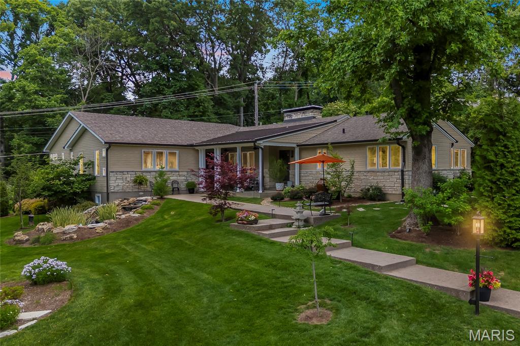 Some homes check boxes. 41 Beaver Drive in Creve Coeur is the kind of place people don't want to leave. A quiet cul-de-sac, an elevated lot, a creek, mature trees, a waterfall koi pond out front, and two covered porches to enjoy the custom landscaping. It sets a pastoral tone.

In 2010, the owners took the home to the studs and completely reclad the exterior, and they haven't stopped improving it since. Inside, the 2400 square feet main level flows the way a home should. Beautifully restored hardwood floors run through the main level, anchored by a great room with a double-sided floor-to-ceiling stone fireplace. The kitchen was fully rebuilt in 2010 with Wellborn cabinetry, granite counters and backsplash, a large island with Thermador cooktop, and Thermador double ovens. The breakfast room off the kitchen has a dedicated coffee bar and wraparound windows looking out to the yard. The library/study with built-in cabinetry works equally well as a home office or a quiet place to read. A Dry Bar and custom shelving in the living area handles the entertaining, and speaker wiring runs through the main living areas and back porch.

The primary suite is the kind of renovation that's hard to replicate. Completed in 2021, it includes a two-person jetted soaking tub, triple rainfall showerheads, custom floating vanity with two sinks, heated floors, pebble stone tile, and a separate water closet. The custom walk-in closet has built-in dressers, shoe storage, and dual hanging sections. The foyer connecting the suite to the main hall has herringbone tile and a gold urchin chandelier that makes an impression every time you walk through it. The half bath was added new in 2021 and the hall bath was updated in 2022.

Outside, the lawn has room to breathe. The front porch and walkway were rebuilt in 2020, the driveway replaced the same year, and professional landscaping was completed in 2020 as well. A custom Anjon waterfall koi pond was installed in 2021, followed by a full Hydrodynamics irrigation system and custom landscape lighting. The outdoor firepit and patio were added in 2023, the same year a new roof was installed. Invisible dog fencing keeps pets safely in the yard.

The garage was fully updated in 2025 with insulation, climate control, epoxy floors, customizable wall storage, and extra outlets for EV adaptability . The semi-finished 300 sf lower level walkout, completed in 2021, adds flexible space for whatever you need it to be.

Three bedrooms, three bathrooms, a quiet cul de sac, convenient to everything. This one is turnkey!