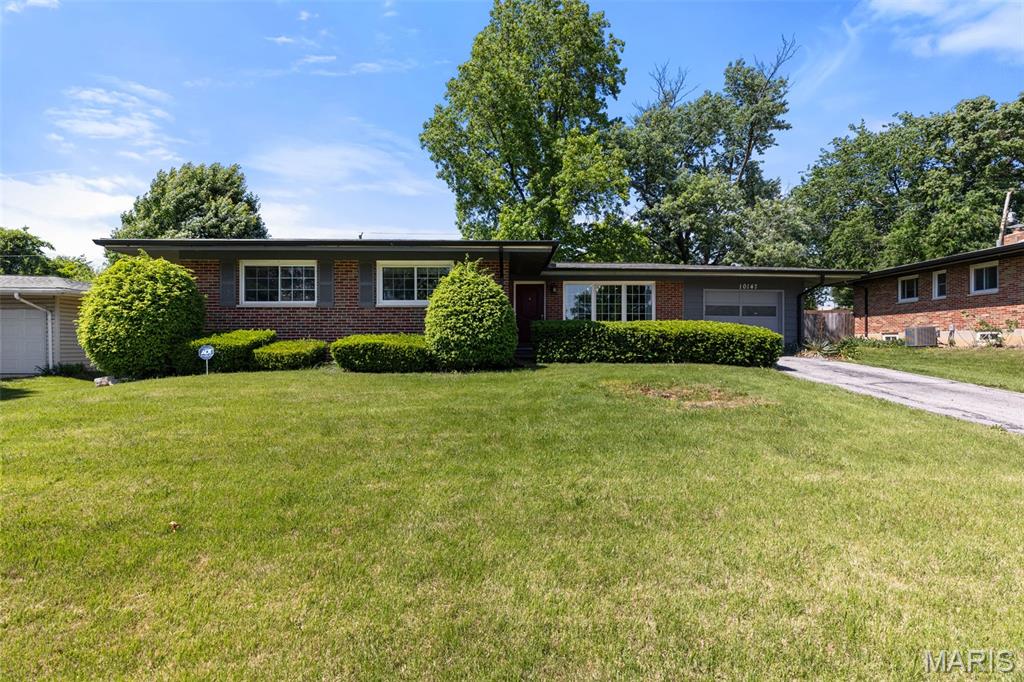 Located in the award-winning Lindbergh Schools district, this beautifully updated brick ranch offers the perfect blend of charm, comfort, and well-designed space. With over 2,100 square feet of total living area, this 3-bedroom, 2-bath home welcomes you with vaulted ceilings, abundant natural light and many recent updates. An inviting open-concept floor plan that provides seamless flow between the kitchen, living, and dining rooms, which are complemented by oversized picture windows and a charming fireplace hearth. The stunning updated kitchen features quartz countertops, newer stainless steel appliances, ample cabinetry, and generous prep space ideal for everyday living and entertaining alike. Recently installed and refinished hardwood floors run throughout the main floor and the bedrooms. The spacious primary suite features two closets and an updated bath. Two additional bedrooms and a full bath round out the main floor. The lower level adds incredible versatility with approx. 780 sq. ft. of finished living space that can be divided to meet your specific needs with areas that are perfect for movies and lounging, a home office and a personal gym. All this and still abundant storage and a newly built laundry room - awaiting your personal touch. Step outside to enjoy the large fenced backyard, complete with mature trees, perennial landscaping, and a welcoming patio. All made more relaxing thanks to the brick privacy wall along the back. An extra-long one-car garage, new roof (2024) and new gutters complete this move-in-ready Crestwood gem — a home that truly has it all.