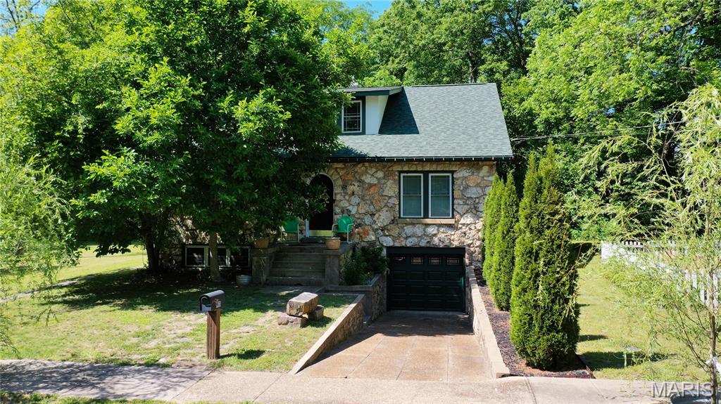 Timeless and full of character, this beautifully updated Arts & Crafts style home offers a rare combination of privacy, space, and convenience right in the heart of Salem. Situated on 1.05 acres m/l adjacent to scenic McMurtrey Creek roadside park, this unique 1931 rock home feels like a peaceful country retreat while still being close to town amenities. Featuring 4 bedrooms, 2 bathrooms, and a full basement, the home welcomes you with gorgeous wood floors, curved archways, and stunning French doors leading into a cozy office space. The updated kitchen showcases rich cabinetry, granite countertops, and abundant storage. Currently operating as an established Airbnb, the property is thoughtfully divided into upper and main level living spaces and generates approximately $15,000 annually in income, offering excellent investment potential or flexible multi-family living options. All upstairs furnishings and items can convey with the sale, and select downstairs items may also convey with an acceptable offer. Outside, enjoy the secluded back deck overlooking the wooded setting, a spring-fed live water creek, wooden bridge, picnic area, fire pit, fenced garden area, and frequent wildlife sightings. Two beautiful Babylon weeping willow trees add to the peaceful park-like atmosphere and natural beauty of the property. The detached 3-car garage provides endless possibilities with additional space ideal for a workshop, hobby room, office, or entertainment area. Relax, entertain, or invest in this one-of-a-kind property offering timeless charm, modern updates, and income-producing potential in one of Salem’s most uniquely beautiful locations.