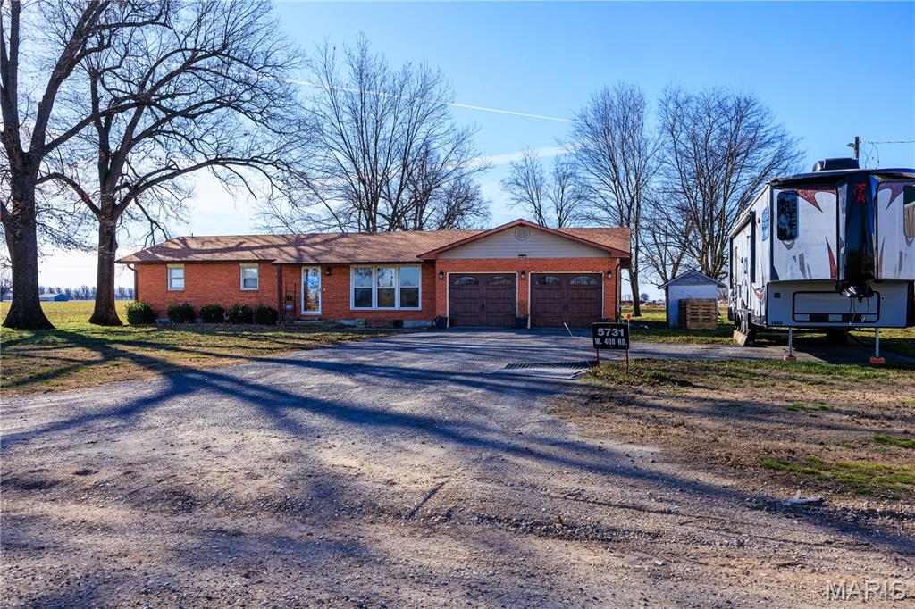 Just minutes from town, this charming brick home offers comfort, space, and unbeatable amenities. The inviting primary suite features elegant French doors that open to a large patio complete with an outdoor kitchen and relaxing hot tub—perfect for entertaining or unwinding at the end of the day. Sitting on 2 acres, the property includes not 1 but 2 incredible shops. The SHOWSTOPPER is the MASSIVE heated 100’ x 60’ shop with 20-foot walls, concrete floors with drains, and quality construction built in 2021. There’s more than enough room for combines, tractors, equipment, and all your toys. An additional 24’ x 36’ shop with concrete floors provides even more storage, workspace, or parking options. This property offers the ideal blend of country living, modern comfort, and unmatched functionality. Don’t miss this rare find!