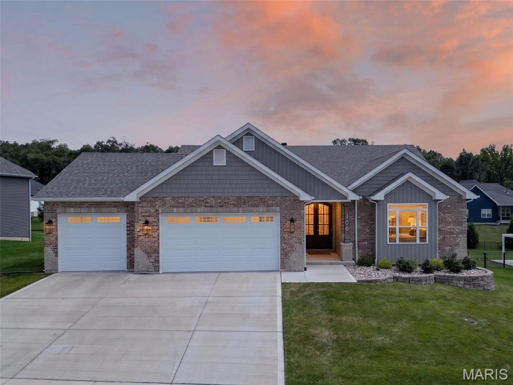 Welcome home to this stunning custom-built 3-year-old ranch with over $125,000 in premium upgrades! From the moment you step through the impressive double front doors with beveled glass, you'll appreciate the exceptional craftsmanship and attention to detail throughout.

The welcoming foyer opens to a spacious great room featuring soaring 11-foot ceilings, a beautiful marble wood-burning fireplace, and mantel that creates the perfect gathering space. The gourmet kitchen is designed for both everyday living and entertaining with 42-inch soft-close cabinetry, granite countertops, tile backsplash, stainless steel appliances, custom lighting, and an oversized center island with breakfast bar, built-in sink, and abundant storage.

The adjoining dining area opens to a maintenance-free covered deck, creating the perfect place to enjoy your morning coffee or unwind in the evening while overlooking the backyard and tree lines. Elegant 9-foot ceilings and crown molding flow throughout the kitchen, great room, and dining area. Durable laminate flooring extends through the main living areas and primary suite, while both bathrooms feature attractive tile flooring.

The spacious primary suite offers a tray ceiling, walk-in closet, and a luxurious en suite bath complete with double vanities, soaking tub, separate shower, and private water closet. A convenient main-floor laundry room includes a utility sink and built-in shelving.

The expansive walk-out lower level provides endless possibilities with a bathroom rough-in, and a sliding door opens to an 11' x 16' covered concrete patio—ready for your custom finishing touches.

Car enthusiasts and hobbyists will appreciate the oversized 35-foot-wide, 3-car garage featuring 8-foot-tall doors. The extra-deep third bay extends 27 feet with a 9-foot-wide door, providing ample room for a boat, oversized truck, workshop, or lawn equipment. Builders transferrable Limited Home warranty.

Situated on a beautifully landscaped 1/3+ acre lot with decorative retaining walls, mature shrubs, and tree line view for added privacy, this exceptional home is conveniently located near schools, shopping, dining, and offers quick access to Hwy. 70.

Luxury, quality, and thoughtful design come together in this exceptional home. Schedule your private showing today—this one won't disappoint!
