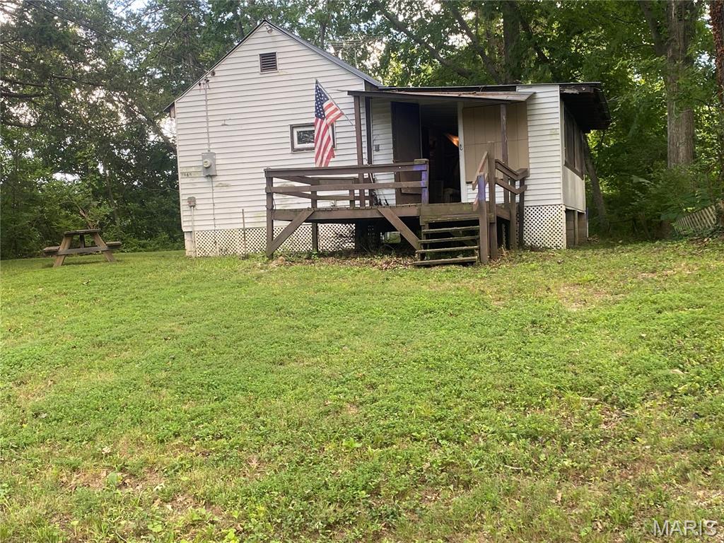Wake up to the sights and sounds of the Big River from this charming cabin nestled on high ground. Enjoy your morning coffee on the porch, spend the day on the water, or gather around the fire in the evening. The beautiful level, cleared lot offers plenty of space to relax, entertain, and enjoy the outdoors, with stairs leading to the dock area (stairs and dock need repair). Bring your kayak, fishing poles, or simply a chair and take in the peaceful river setting.

Electric is connected. The property has an operational well, and the septic system is believed to be operational, however, neither the well nor septic have been inspected by the seller.  Seller has owned the property since 2024 but has never occupied it. To the seller's knowledge, water has never entered the home. Property is being sold AS-IS. Agent Owned. Buyer to verify all information deemed important, including the condition of the well, septic, utilities, floodplain, and intended use.