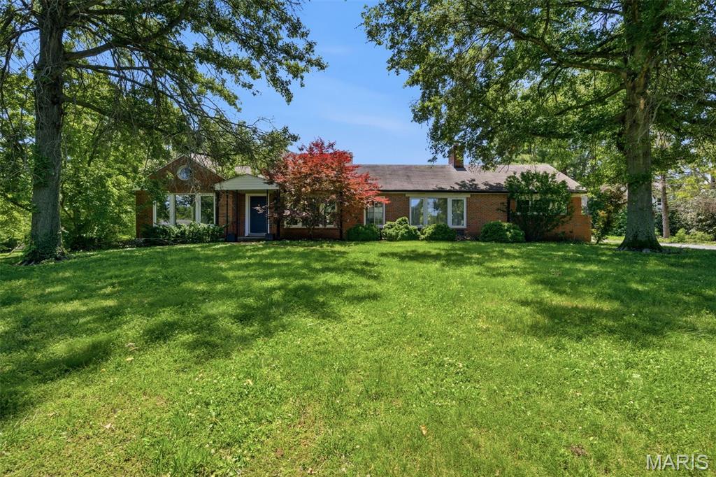 Positioned on nearly 1.2 acres at the end of a picturesque cul-de-sac in Frontenac, this property presents a rare opportunity to create something truly special in one of St. Louis County's most sought-after locations. Surrounded by mature shade trees and established luxury homes, the setting offers exceptional privacy, space, and potential within the award-winning Ladue School District.  The existing home offers nearly 4,500 square feet of living space across three levels, featuring 5 bedrooms, 2 full baths, 2 half baths, and a desirable main-level primary suite. Inside, generous room sizes, multiple living and gathering spaces, a large family room with a wood-burning fireplace, a formal dining area, and expansive lower-level recreation spaces provide a substantial foundation for those looking to renovate and reimagine the home. Original architectural details and built-ins offer a glimpse into the home's character, while the flexible floor plan creates endless possibilities for modernization.  For those seeking new construction, the expansive lot and surrounding streetscape provide an exceptional setting for a custom luxury residence. With neighboring high-end homes already established throughout the subdivision, this is an opportunity to build in a location where demand continues to remain strong.  Conveniently located just minutes from Clayton, Highway 40, premier shopping, dining, hospitals, and top-rated schools, the property combines a peaceful residential setting with easy access to everything this location has to offer.  Whether your vision is a comprehensive renovation or a custom new build, opportunities like this are becoming increasingly rare. Bring your ideas and unlock the potential of one of Frontenac's most desirable settings.