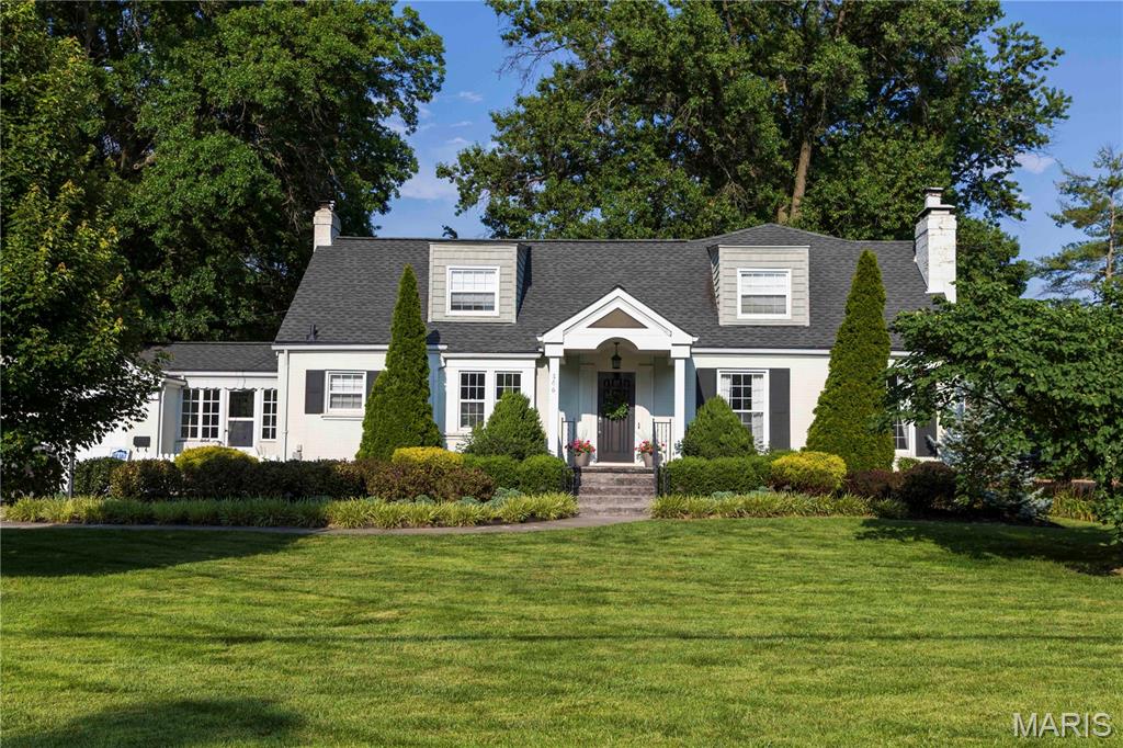 Welcome home to this Kirkwood charmer, featuring gleaming hardwood floors, graceful arched doorways, and stately millwork throughout. The picturesque setting includes a large, shaded backyard with a back gate opening directly into Tillman Elementary — say goodbye to the carpool line! An oversized stamped concrete driveway and inviting front porch welcome you inside, where the foyer opens to a spacious living room with a cozy fireplace, perfect for relaxing or entertaining.  The kitchen features a center island, double ovens, and a handy planning desk, flowing seamlessly into the sunny breakfast room overlooking the backyard. The main-floor primary suite is a true retreat, offering two walk-in closets, a tray ceiling, and a spa-like bath with a whirlpool tub, separate shower, and double-bowl vanity. Rounding out the main level is a formal dining room, half bath, laundry room, and enclosed side porch.  Upstairs, you'll find a bedroom with a private bath, cedar closet, and custom built-ins, plus a spacious media room and two additional bedrooms with generous closet space — all served by another full bath. The partially finished lower level adds even more living space with a family room, fireside sitting area, half bath, and rec room.  Step outside to the newer composite deck and patio overlooking a large, level, fully fenced (vinyl) yard — ideal for outdoor gatherings.