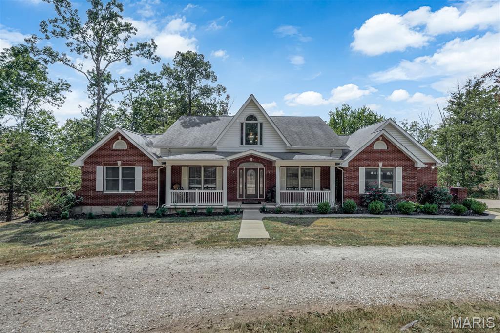 Beautiful 1.5 story home on 11+ acres with private pond. This home features 3 bedrooms, 3 full bathrooms and 2 half bathrooms with an attached 3-car oversize garage. You are welcomed with a nice large covered front porch that leads you into the entry foyer and living room boasting tons of natural light from the surrounding windows, gorgeous hard wood flooring throughout, high vaulted ceilings with an open stairway to the upper level. The eat-in kitchen is complete with beautiful custom wood cabinets, stainless steel appliances, farmhouse apron sink on the center island with a breakfast bar and a large walk-in pantry. Be sure to check out the cozy wood burning fireplace adding some extra charm to this country style kitchen. Master bedroom is on this main level with a large master bathroom including an oversize double vanity with tons of storage, walk-in shower and a garden tub. There is an additional room on this main level that could be used as a formal dining room or turned into an office/den. Completing the main level of this home is a convenient half bath and main floor laundry room. Upstairs you will find a nicely sized open loft area that looks out over the living room along with 2 jack & jill style bedrooms, connected full bath with large vanity and step-in shower. The walk-out basement has been partially finished with a large family room area with a beautiful brick wood burning fireplace. You will find a huge separate room perfect for a personal in home gym or office that boasts floor to ceiling windows with a clear view of the pond. Also on this level is a complete second eat-in kitchen with stainless steel appliances, tons of cabinet storage and counter space. Tons of convenient storage space completes this lower level. Onto the exterior you will enjoy the patio and large back deck overlooking the beautiful, stocked private pond that is perfect for relaxing on a nice day or entertaining guests. This home sits on a gorgeous corner lot surrounded with natural foliage and wildlife. Do not hesitate in making your appointment today to come see this beauty!