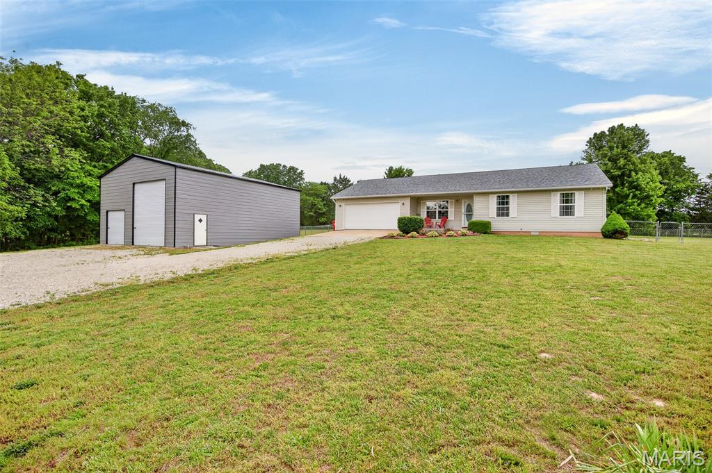This very well-maintained 3 bedroom, 2 bathroom home sits on 3.01 beautiful acres and offers the perfect blend of comfort, updates, and outdoor space. From the moment you arrive, you'll notice the expansive yard, partial chain link fencing in the backyard, and the pride of ownership throughout the property. Step inside to an inviting open floorplan featuring updated paint, vinyl plank flooring throughout, and a freestanding wood stove that adds warmth and charm to the living space. The kitchen is both stylish and functional with updated granite countertops, stainless steel appliances, and a dedicated coffee bar area perfect for busy mornings or entertaining guests. Down the hall, you'll find three spacious bedrooms, including a primary suite with a large closet and beautifully updated bathroom showcasing a tiled walk-in shower. Out back, enjoy a fantastic outdoor living space ideal for relaxing on warm summer nights. The impressive 30x40 shop includes concrete floors, electric, and an RV electric hookup, offering endless possibilities for storage, hobbies, or workspace. With a newer roof installed in October 2023 and so many quality features throughout, this move-in ready property won't last long!