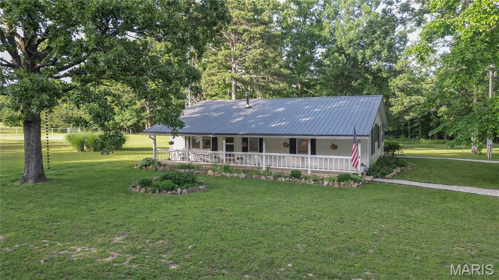 Looking for the complete hobby farm setup? This exceptional 10-acre property is fully fenced and cross-fenced with three gated entrances, making it ideal for livestock, horses, and country living. The 4-bedroom, 1-bath home features central heat and air, a wood stove for backup heat, rural water, and a private well. The property includes two ponds, one of which is stocked for fishing. Outbuildings are ready for immediate use and include a barn with water and electric, a fully equipped chicken coop and run, a horse stable with concrete floors, water, and electric, and a 3-car garage built in 2021 with concrete floors and electric service. An added bonus is the fully furnished tiny house that is currently income-producing and perfectly suited for Airbnb or guest accommodations. This turnkey farm comes complete with chickens, donkeys, a 2022 John Deere 4x4 diesel tractor with multiple attachments, and a zero-turn mower with cyclone attachment. Located less than one mile from Big Piney River access, this property offers the perfect combination of farming, recreation, and investment potential. Rarely does a property come available with this many amenities and income-producing opportunities already in place.