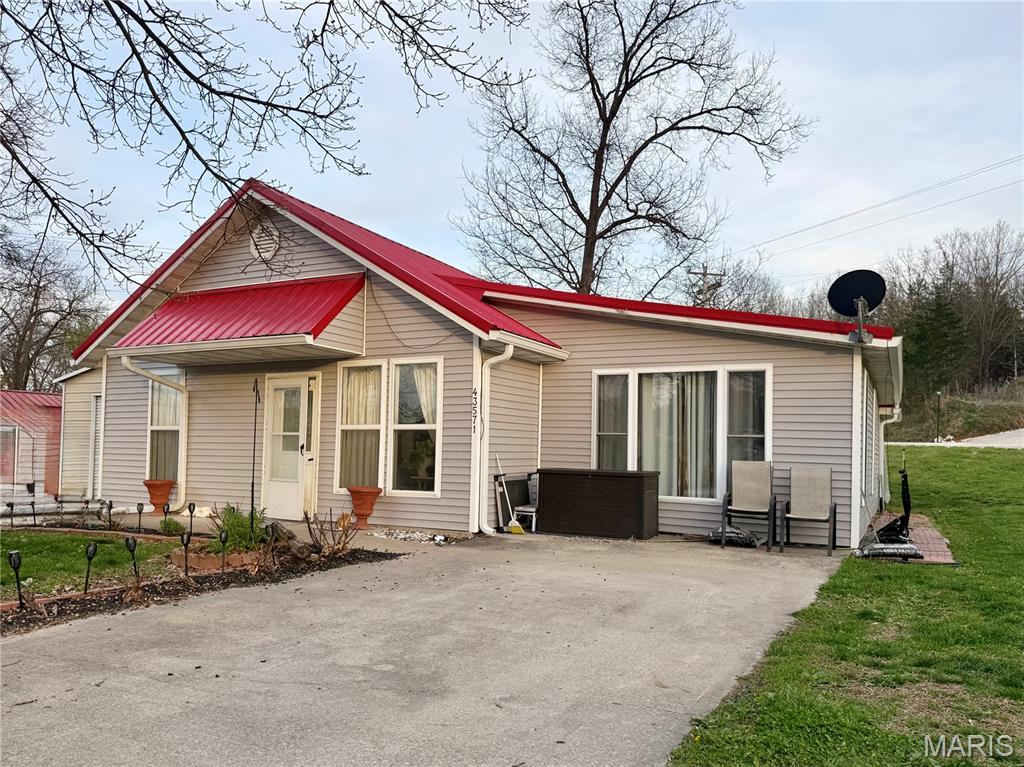 This main level living home is located just off Rt J only minutes to Mark Twain Lake. Boating, fishing, swimming all at your fingertips! There is a detached garage and a "she-shed" (both have electricity). The current owners widened the driveway so there is easy access for parking a camper or boat. The drive connects Blue Lagoon and Willow so drive right through! The roof over the back patio/porch has been extended and "curtain like" tarping around it during the winter helps keep the space usable all year long. In the summer, take it down for an open air area to entertain friends and family! Inside you will find a spacious living room, and dining room. In the kitchen,  new cabinets, countertops and backsplash. New lighting, ceiling fans and flooring! Lots of updates.  Right now the home is set up with two bedrooms but there is another room that can easily be a third bedroom. You just need a wardrobe or closet installed. It's currently being used as storage and laundry.  The home has no steps to enter so easy access for everyone. The HVAC is 3 years old, metal roof is about 7 years. If you are looking for a summer home near the lake or a full time residence, you need to take the time to check this one out.