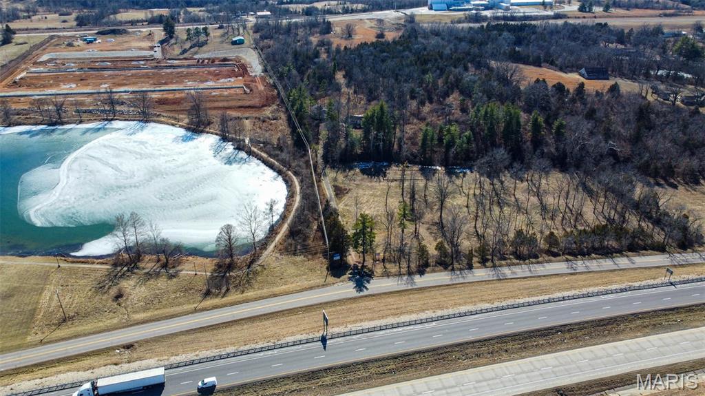 This property has 12.99 acres m/l acres with 497 feet of I-44 frontage located adjacent to Blue Lake and the Rolla City Limits. This location offers development potential and with it's I-44 exposure and nearby recent development would make a great location for any business. The property is nestled in a beautiful, wooded setting with lake, valley and sunset views, mature walnut and oak trees, and a creek. The interstate exposure and location close to town provide lots of commercial possibilities with the option of having living quarters on site. Location: Hwy/Interstate Front