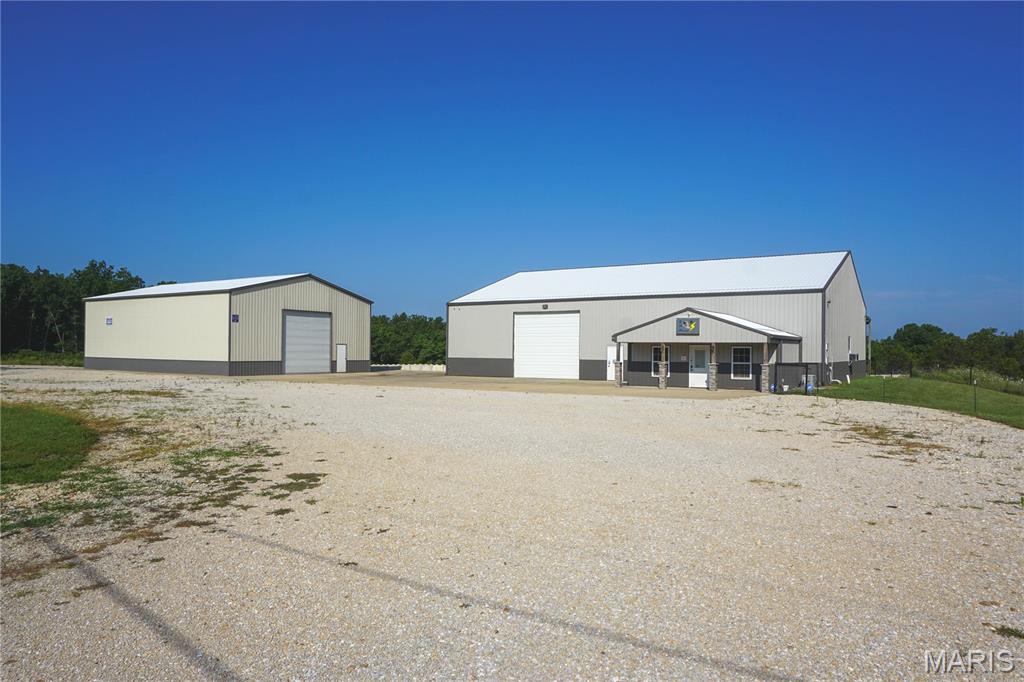 Exceptional commercial and development opportunity on 47.21 acres m/l just minutes from Rolla! Enjoy the convenience of being close to town while benefiting from the space, privacy, and expansion opportunities this property provides. The main 60 x 80 building features a climate-controlled shop with office, full bath with shower, heavy-duty concrete floors, three-phase power converter, dedicated paint bay with ventilation, concrete loading dock, and a covered concrete lean-to. A second 40 x 60 building includes a 16-foot overhead door, reinforced concrete flooring, and additional shop or storage space.

Approximately 2 acres m/l are leveled and graveled for equipment, trailers, or vehicle parking, while the remaining acreage offers room for expansion, future development, or additional commercial operations. Well suited for manufacturing, fabrication, contractor operations, trucking, warehouse/distribution, equipment sales, and many other commercial or industrial uses. Seller will also consider selling the buildings with approximately 4 acres m/l for $699,000.